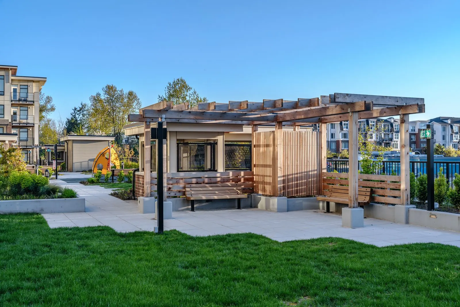 Lawn and covered timber seating pavilion in a courtyard at Spark