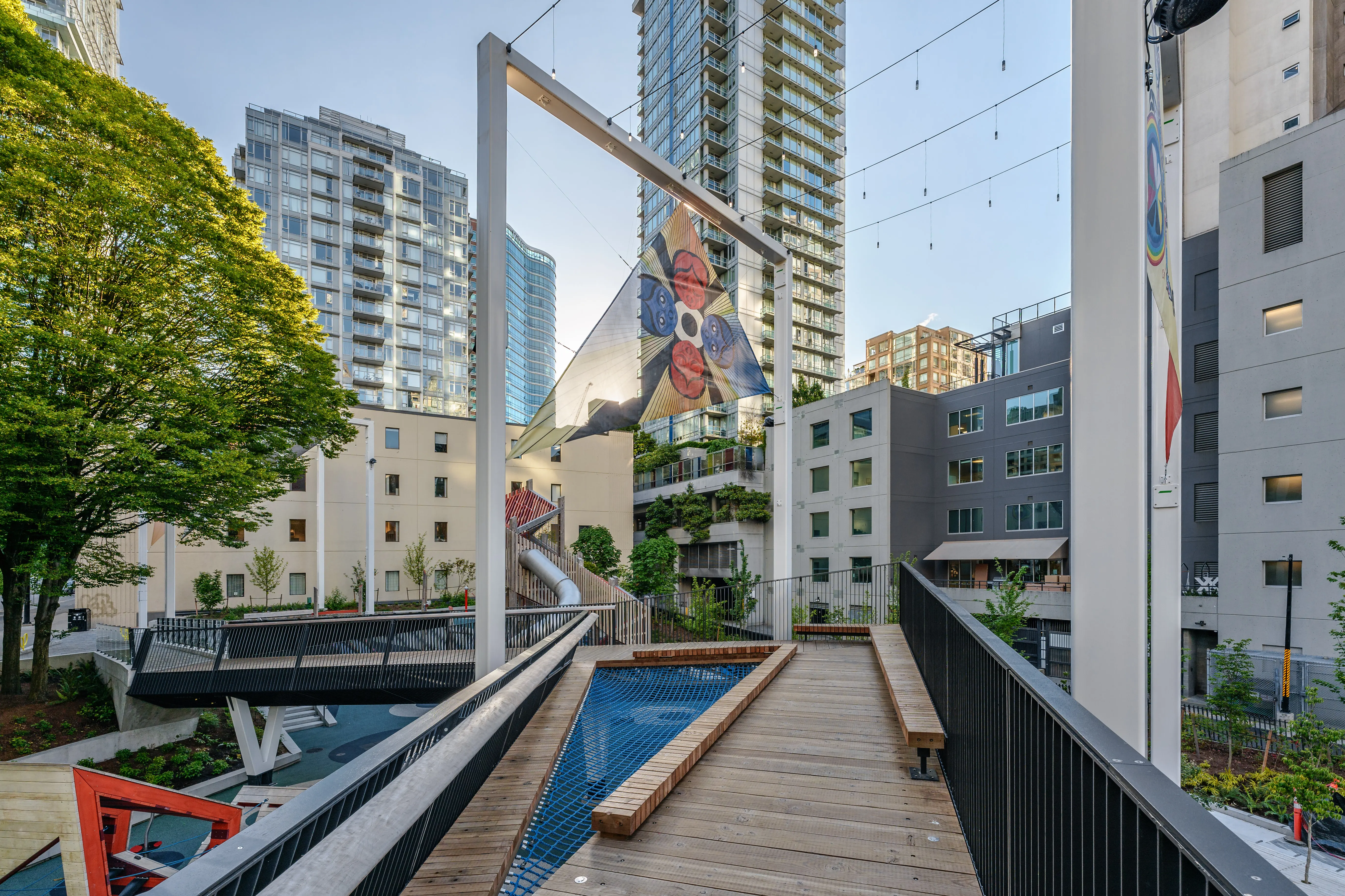 Timber boardwalk and water feature between towers at Rainbow Park Downtown