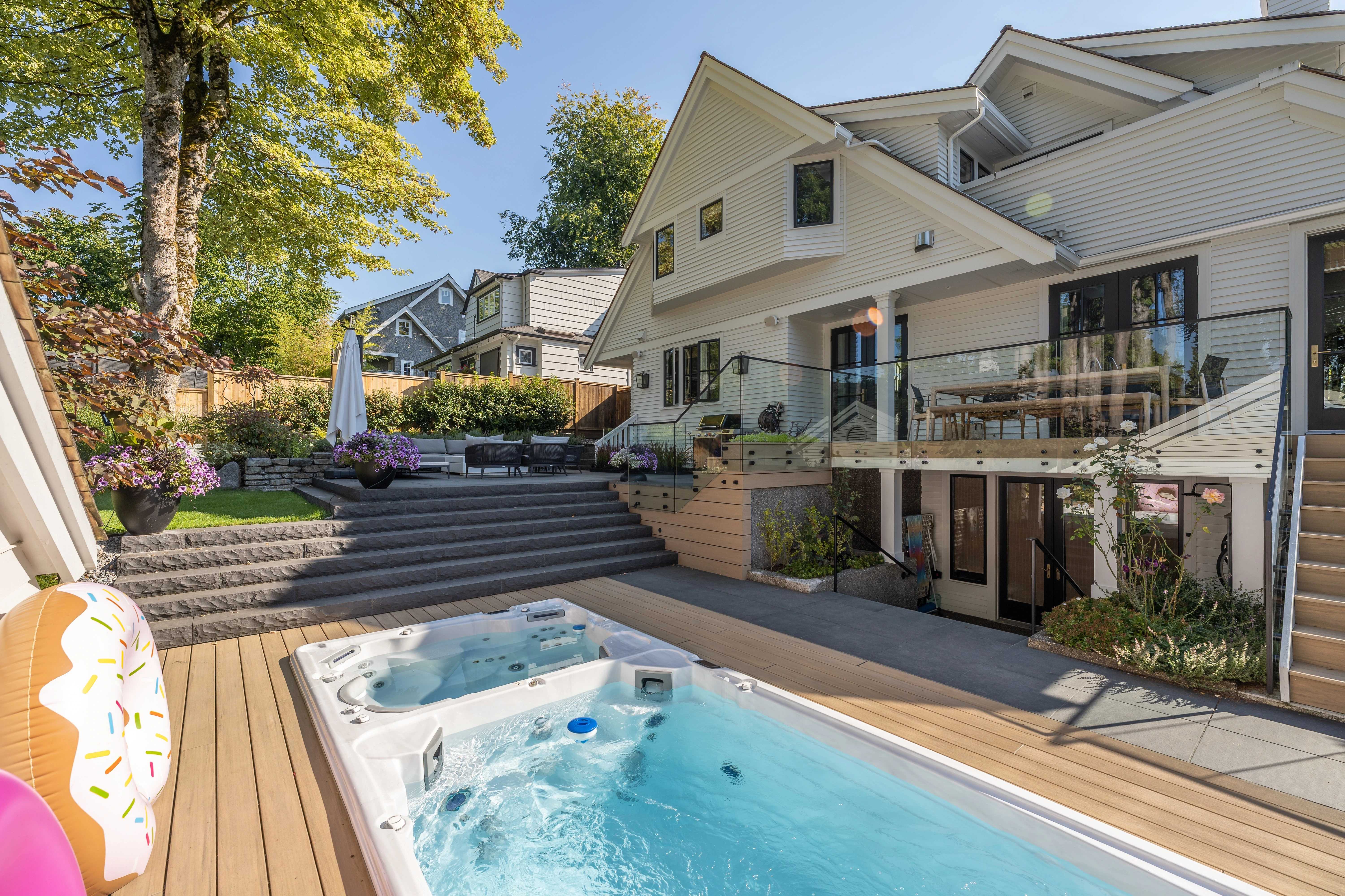 Backyard swim spa with timber deck and garden at MacKenzie