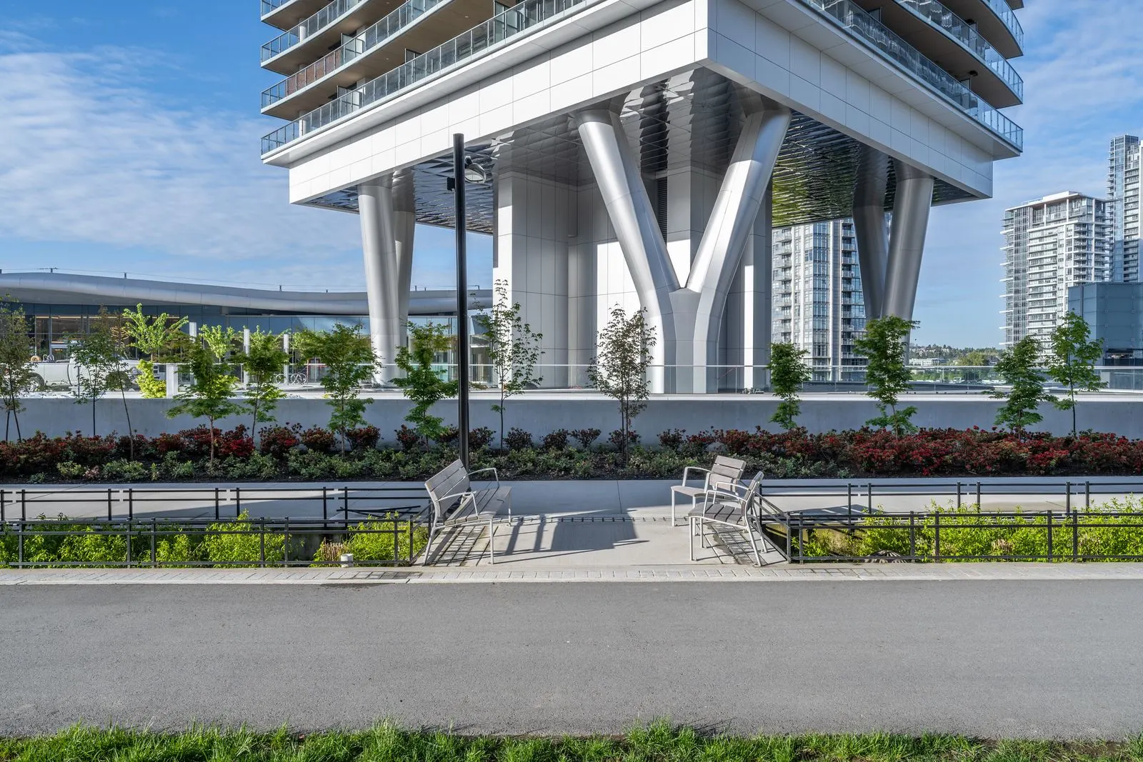 Planting beds and benches below a tower podium at Brentwood 1B