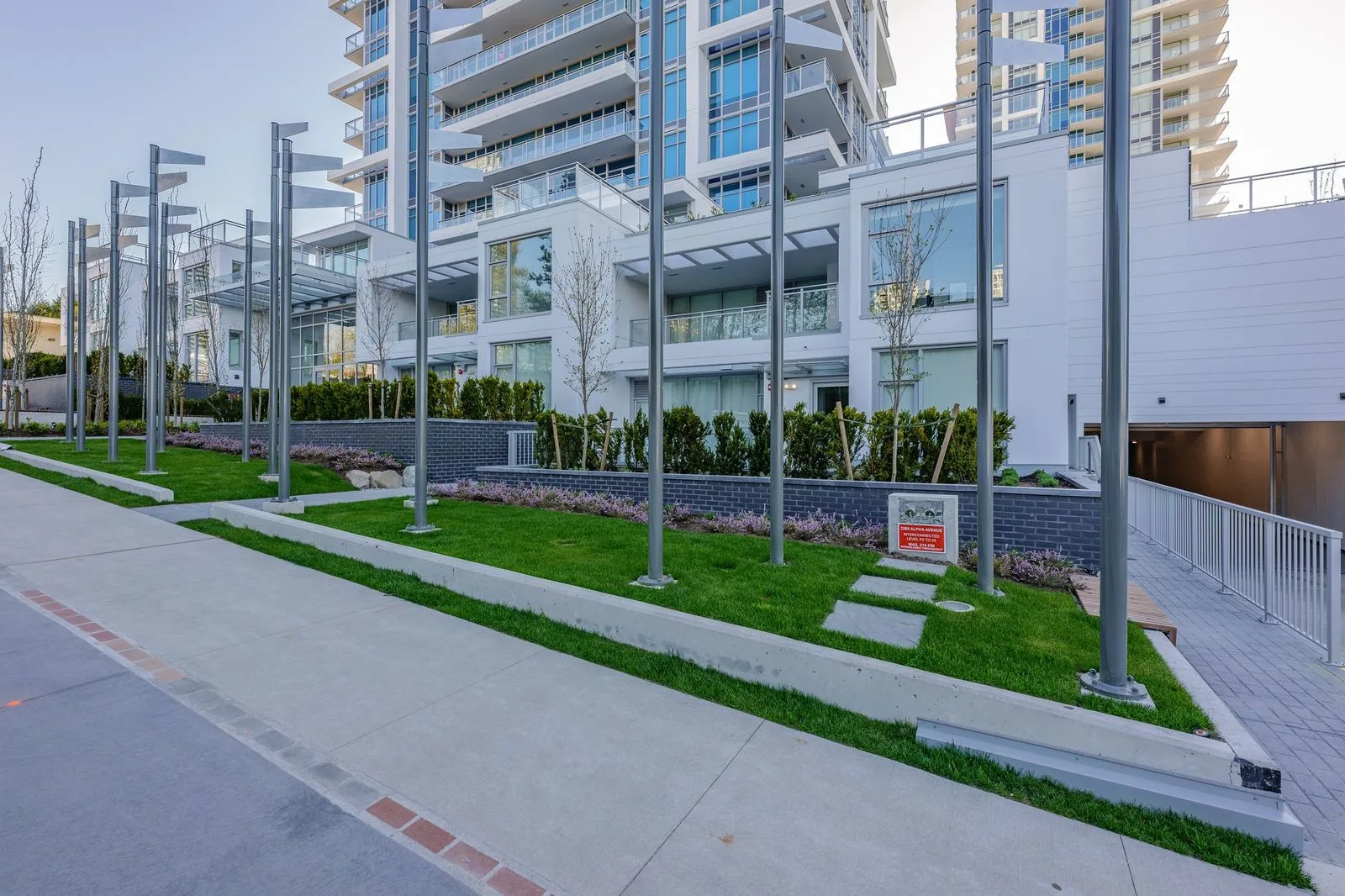 Lawn strips and light poles along a residential walkway at Alpha Lumina