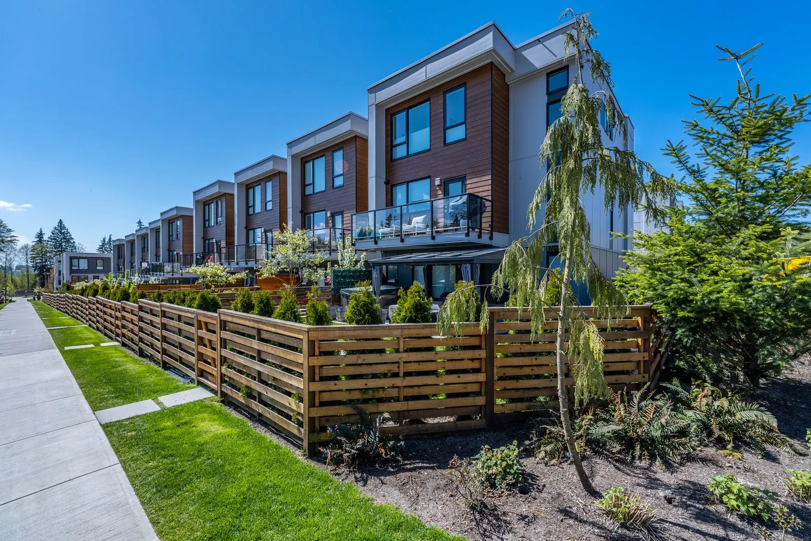 Timber fence and front yard planting along townhomes at Seymour Village Amenity Park