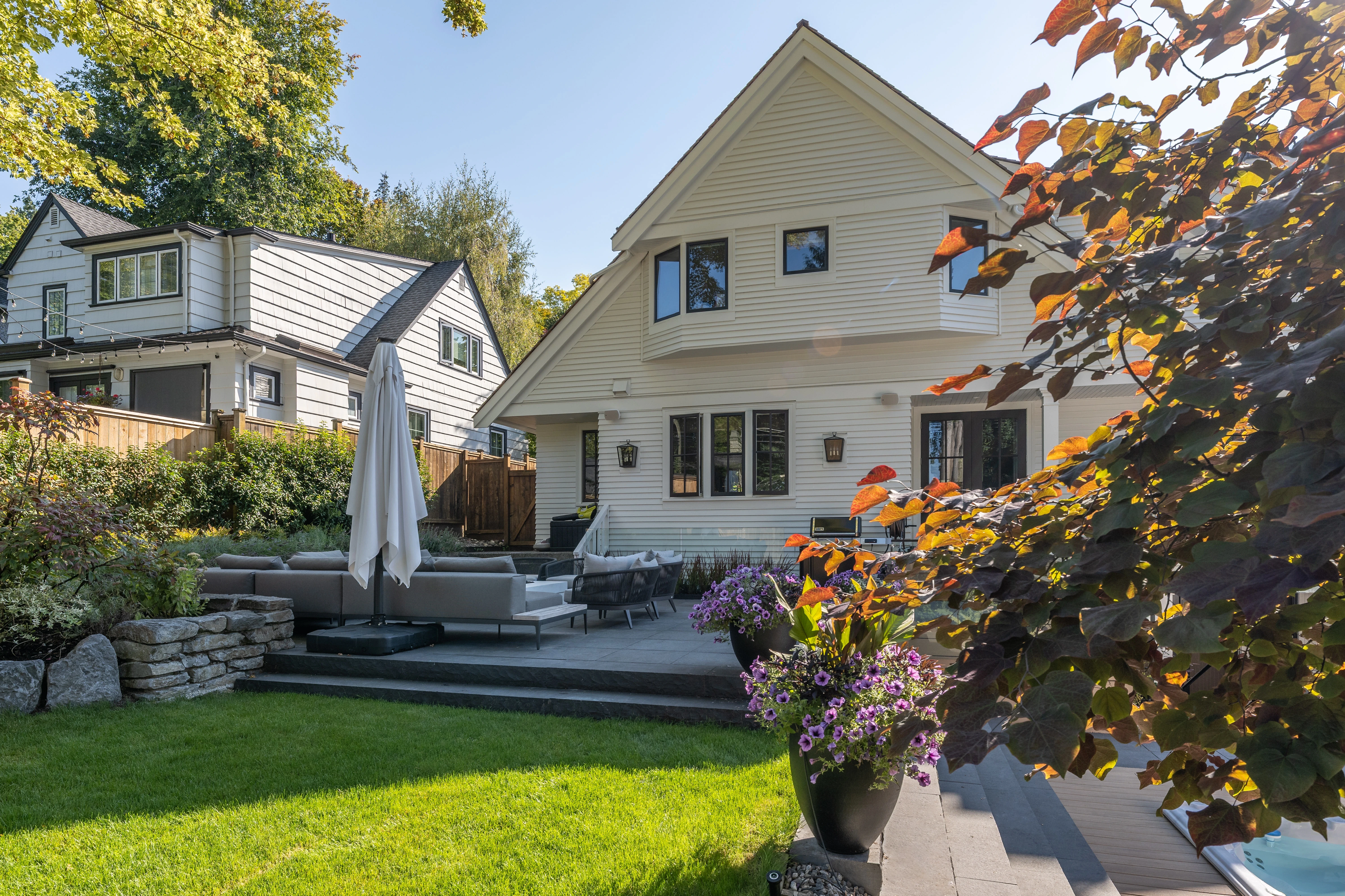 Backyard lawn, patio and planting behind a house at MacKenzie