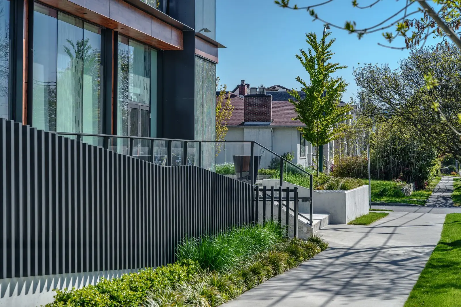 Sidewalk planting and metal fence along a building at The Parker