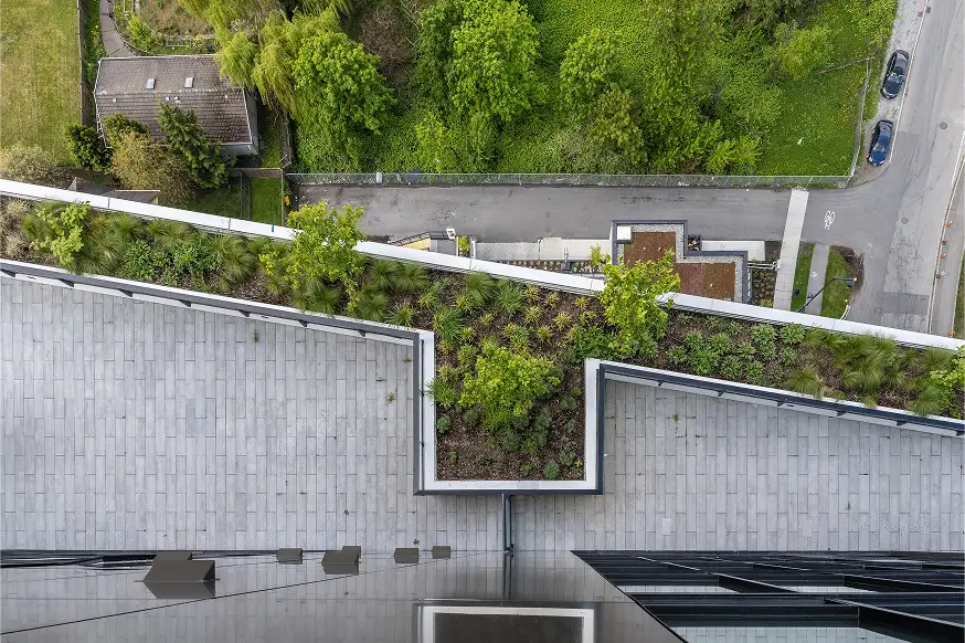 Aerial view of a stepped green roof planting along a building edge