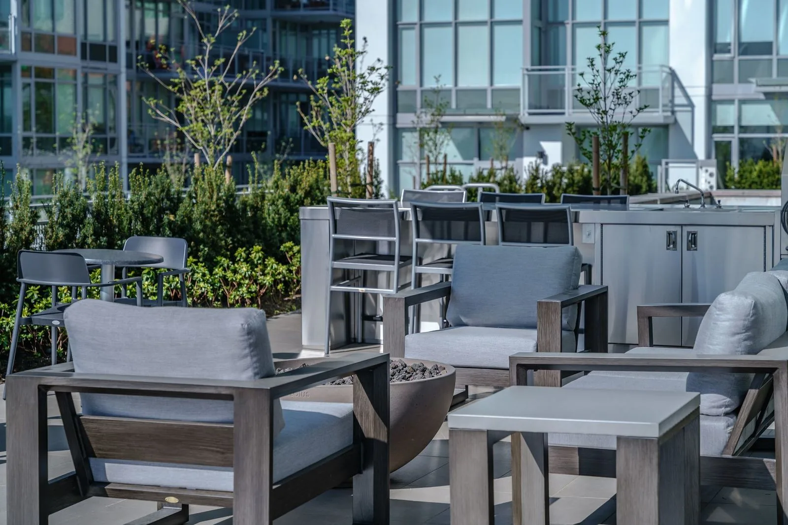 Outdoor lounge furniture on a planted rooftop terrace at Brewery District 6