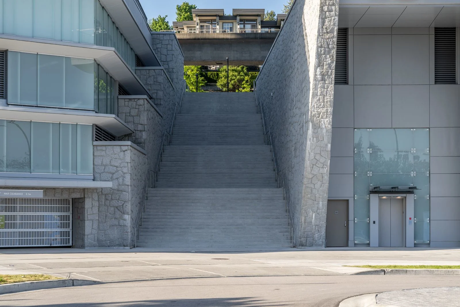 Wide stone-clad stairway between buildings at Brentwood 1A