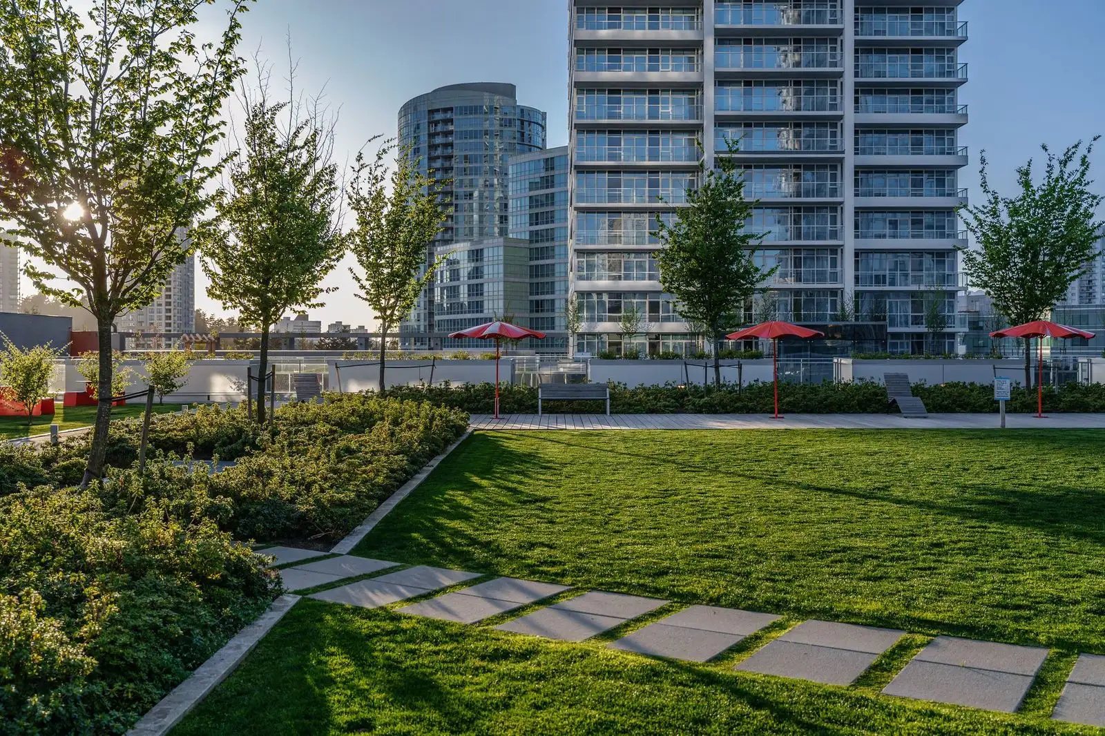 Rooftop lawn with stepping stone path and young trees at Station Square 2 and 3