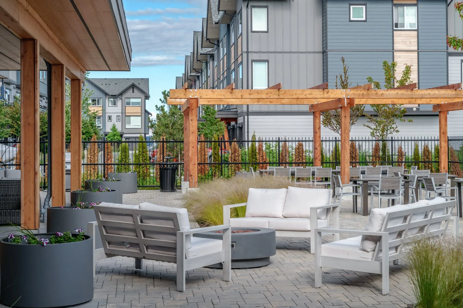 Outdoor lounge seating and planters beside a timber pergola at Boardwalk