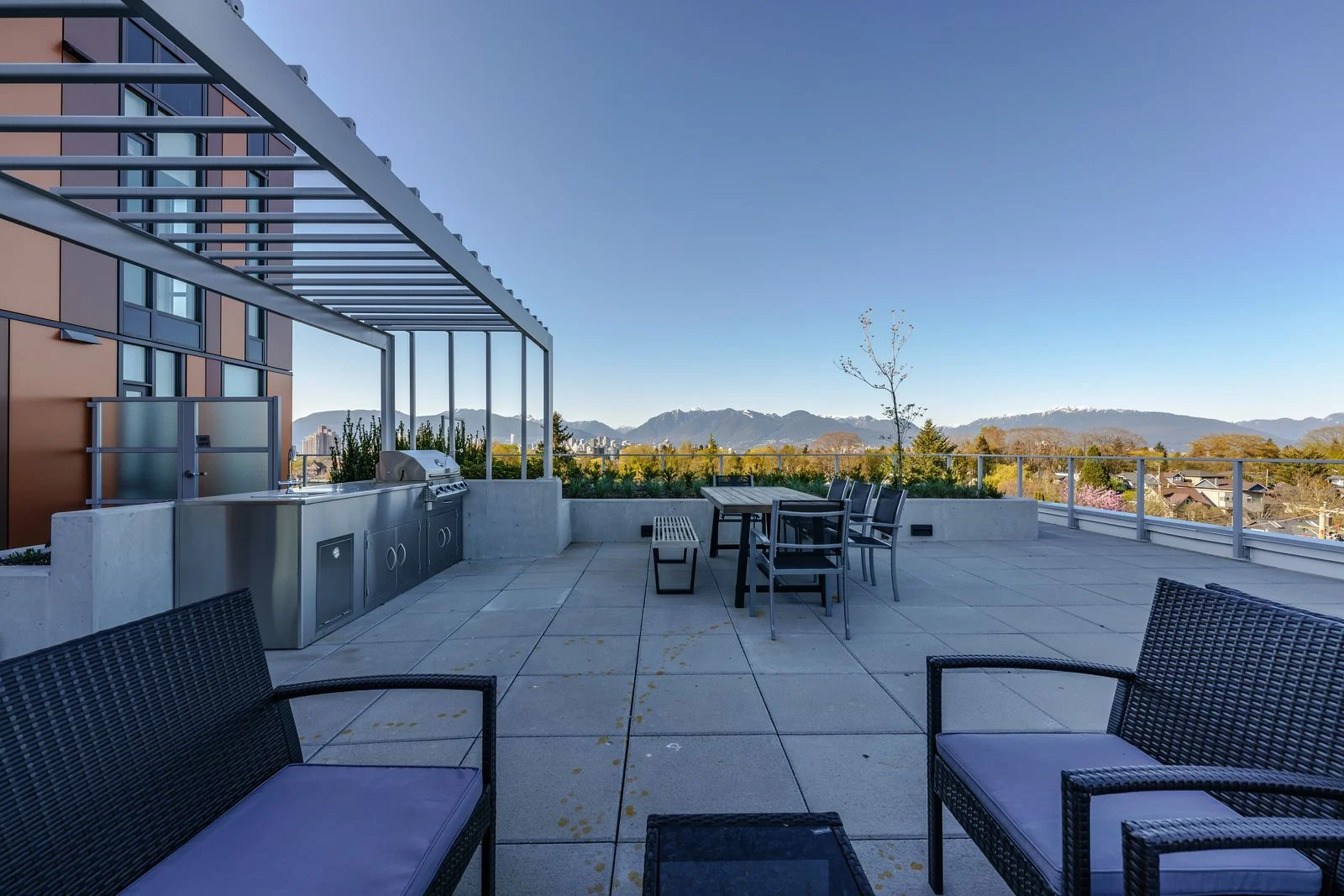 Rooftop terrace with lounge seating and outdoor kitchen at Marquise
