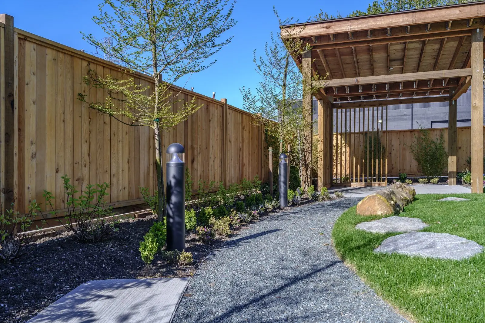 Gravel path, stepping stones and timber fence at The Grove Presentation Centre