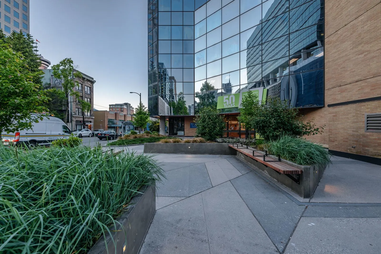 Grass planting and benches on a campus plaza at Vancouver Community College