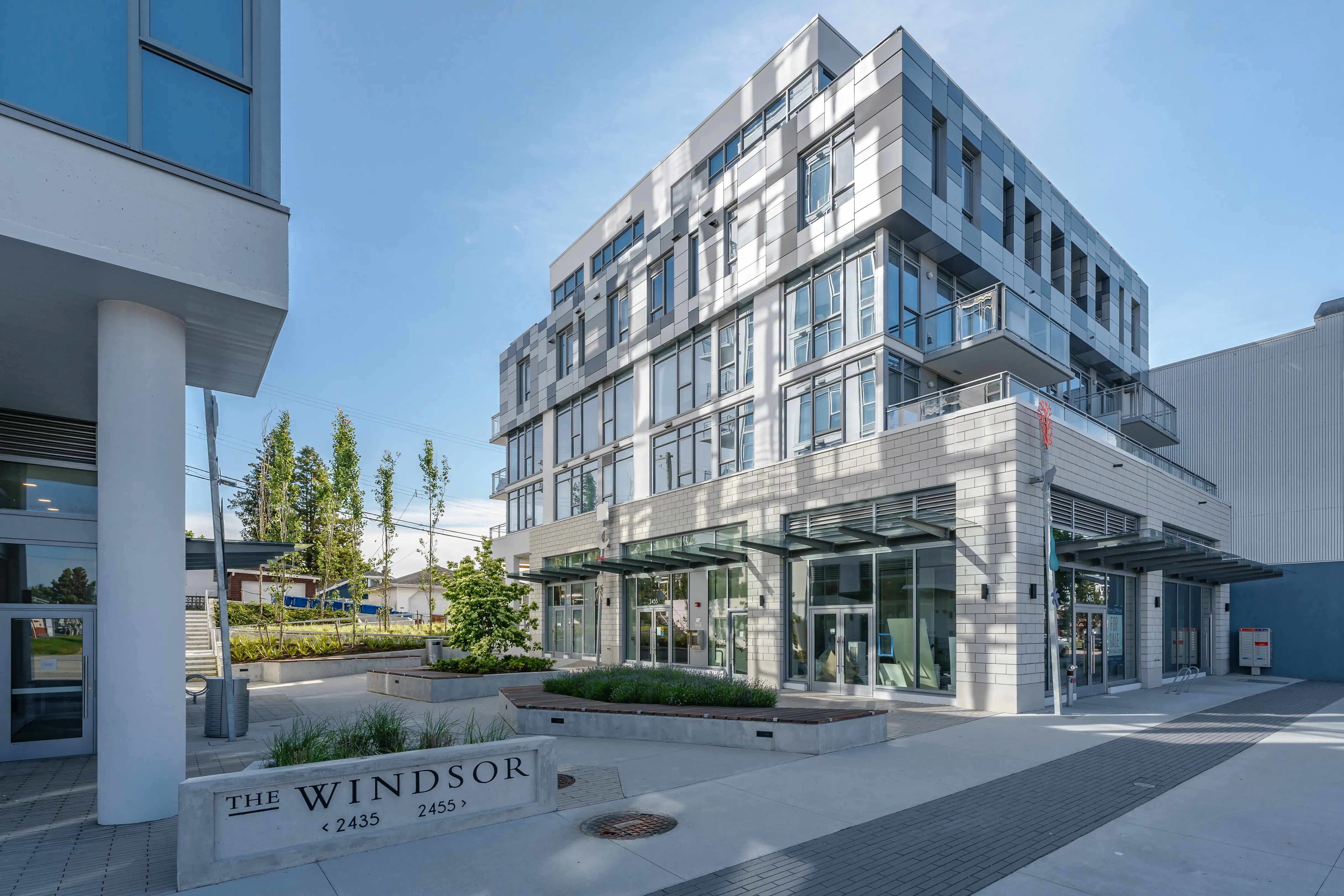 Entrance plaza and sign with planting at The Windsor