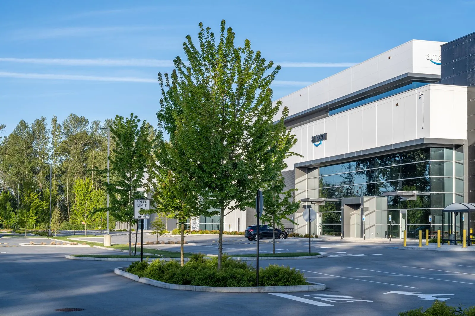 Young trees and planting at a warehouse parking area at Riverbend Amazon Warehouse