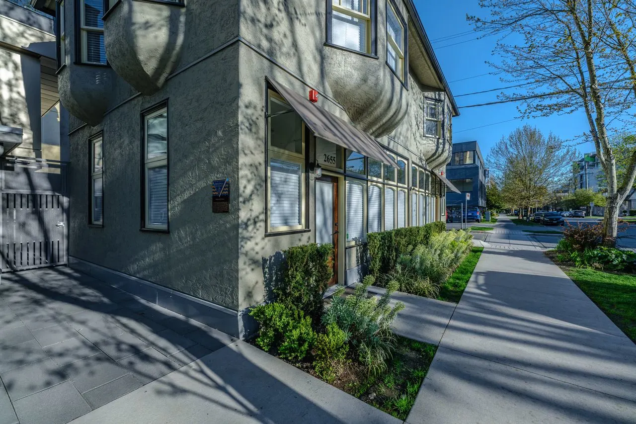 Sidewalk and foundation planting along a townhome facade at Eleven West