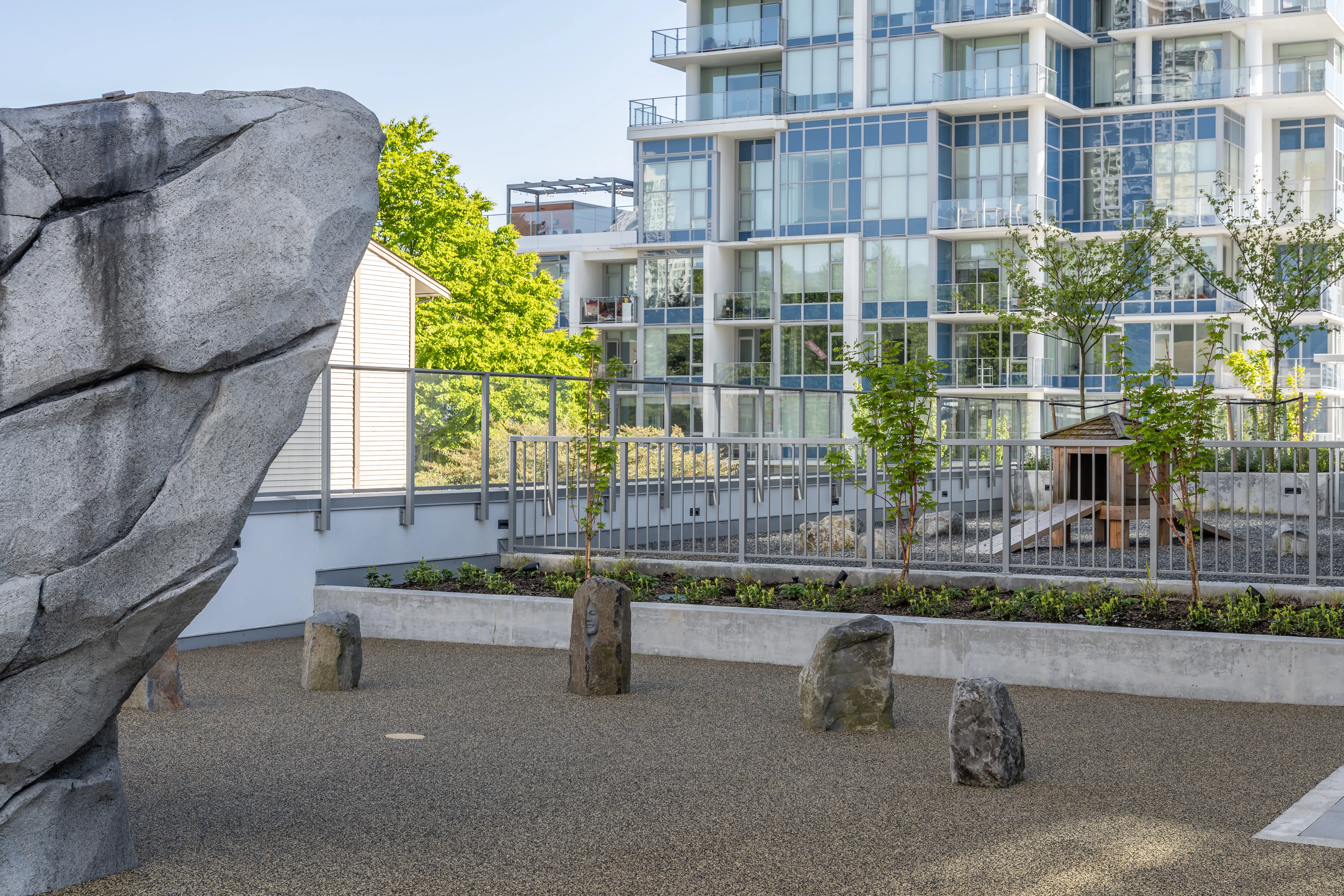 Climbing boulder and log stumps in a rooftop play area at Meridian