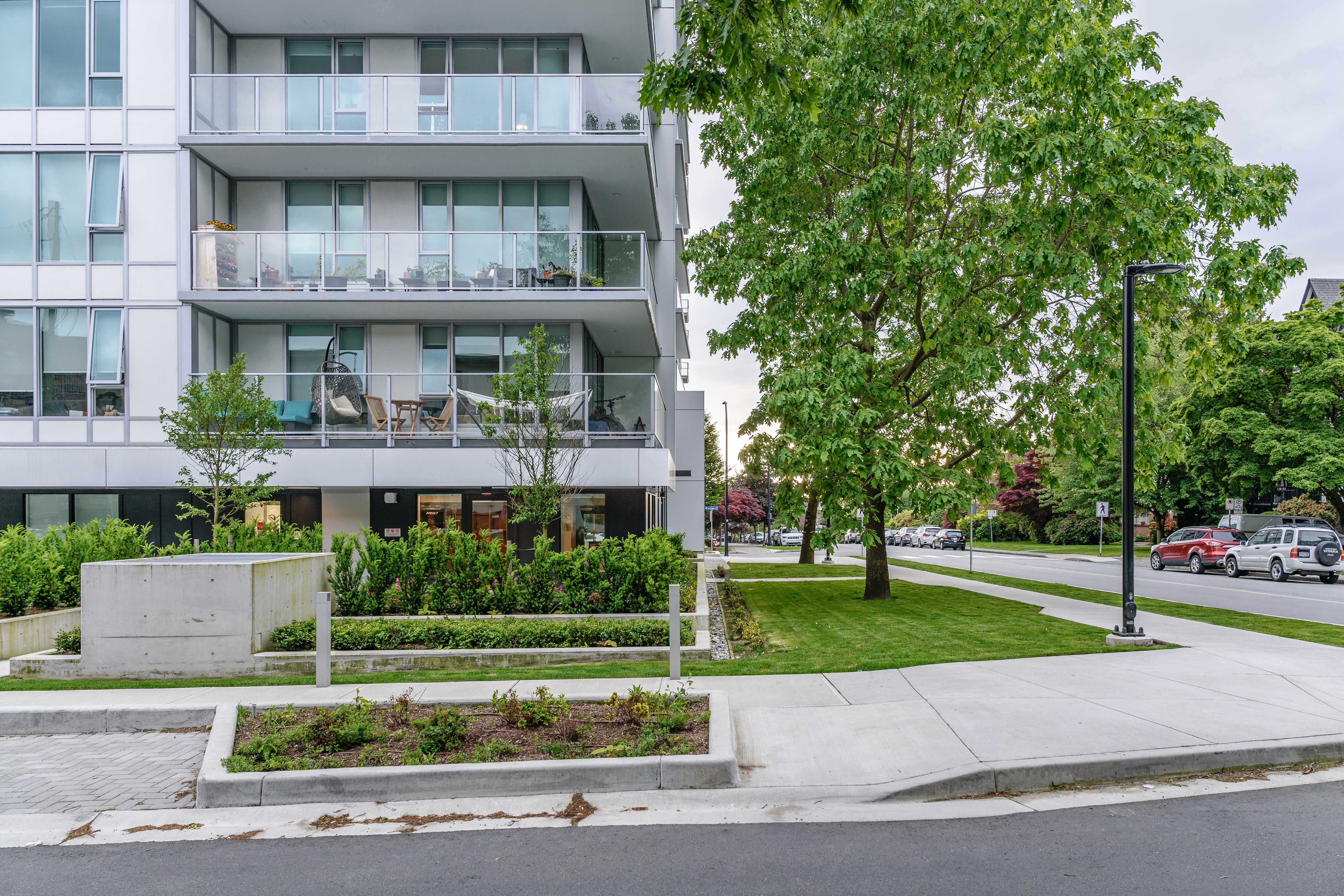 Street frontage planters and lawn at a residential tower at Origin