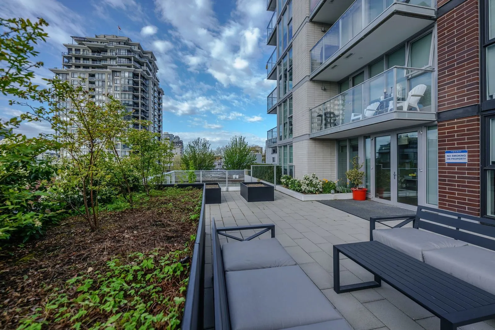 Rooftop terrace with lounge seating and planting at The Beverley