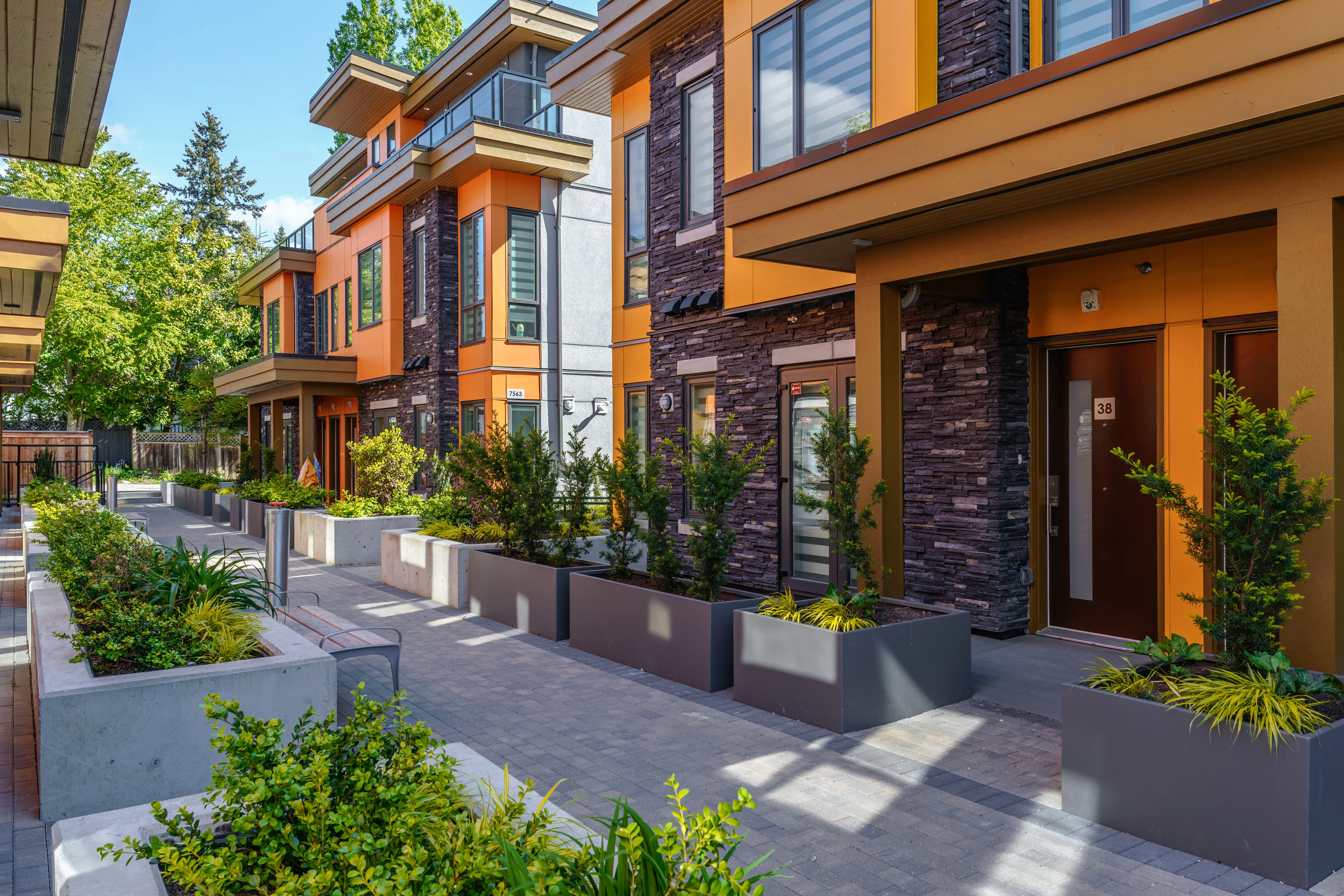 Planters and shrubs along townhome entries at Terraces at Oak Park