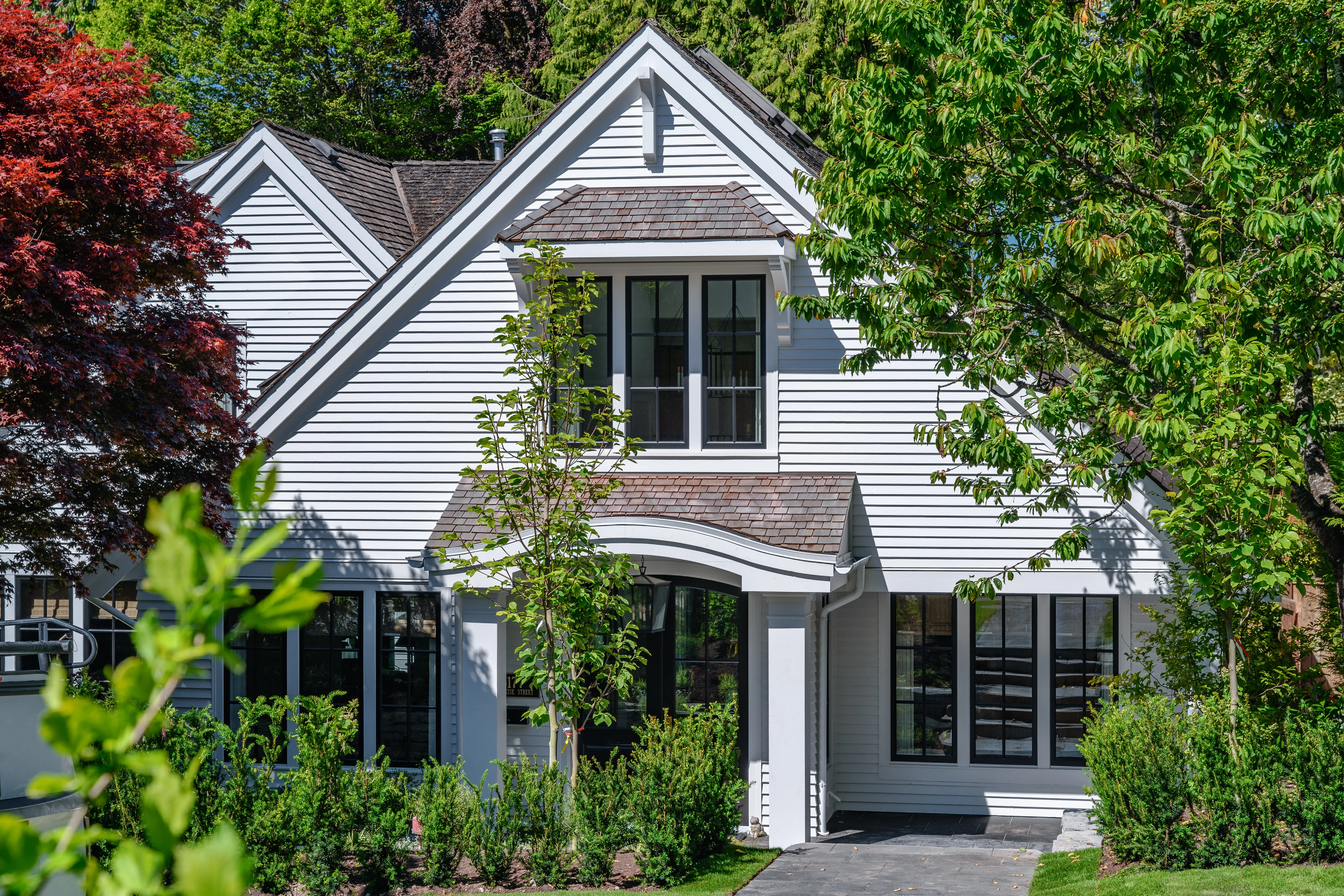 Front garden planting at a white two-storey house at MacKenzie