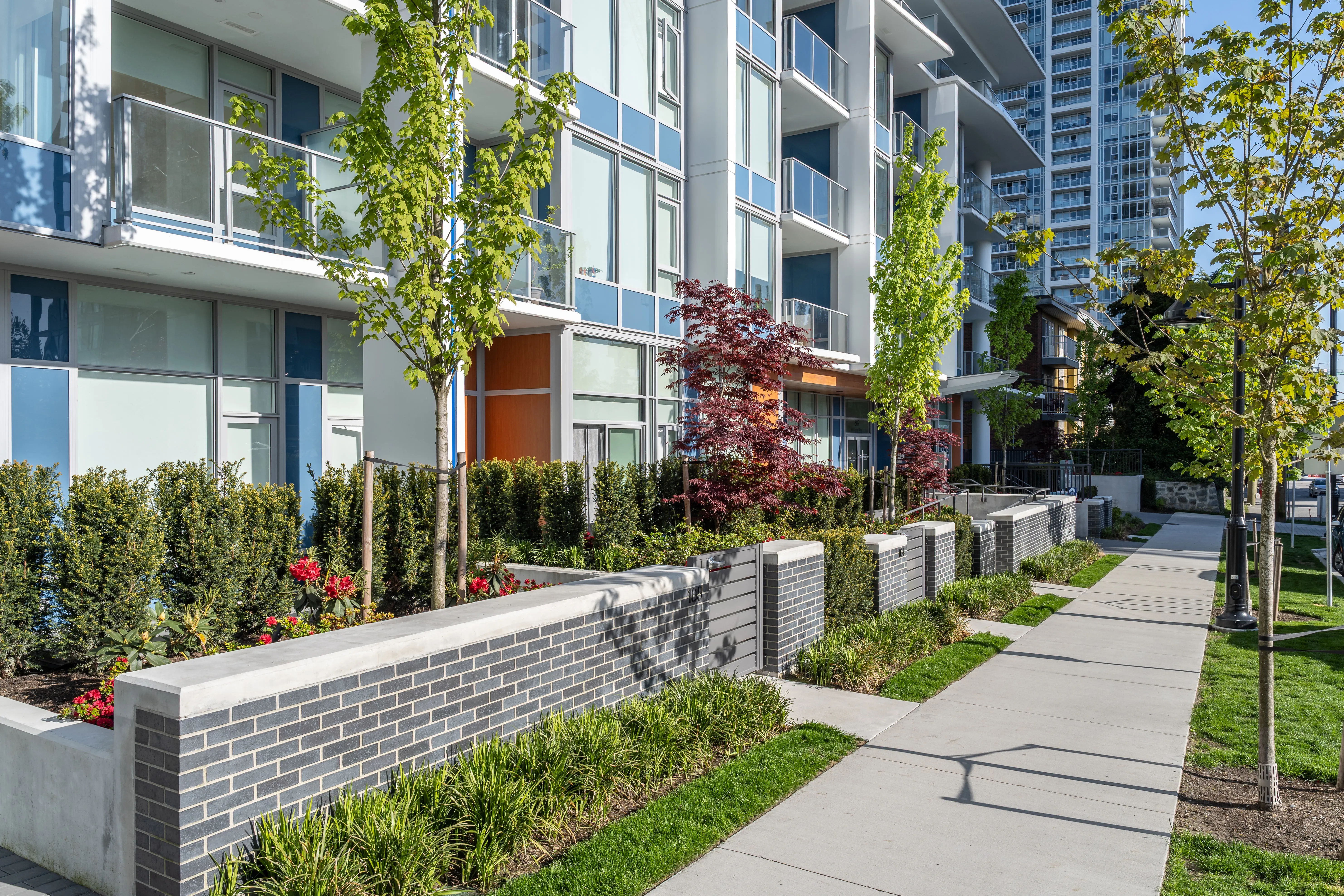 Brick planters, young trees and sidewalk at Precidia