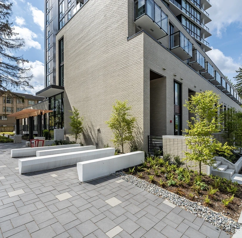 Paver plaza with concrete benches and planting at Melrose