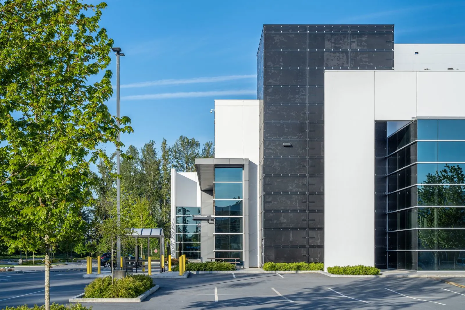 Trees and planting beside a warehouse entrance at Riverbend Amazon Warehouse