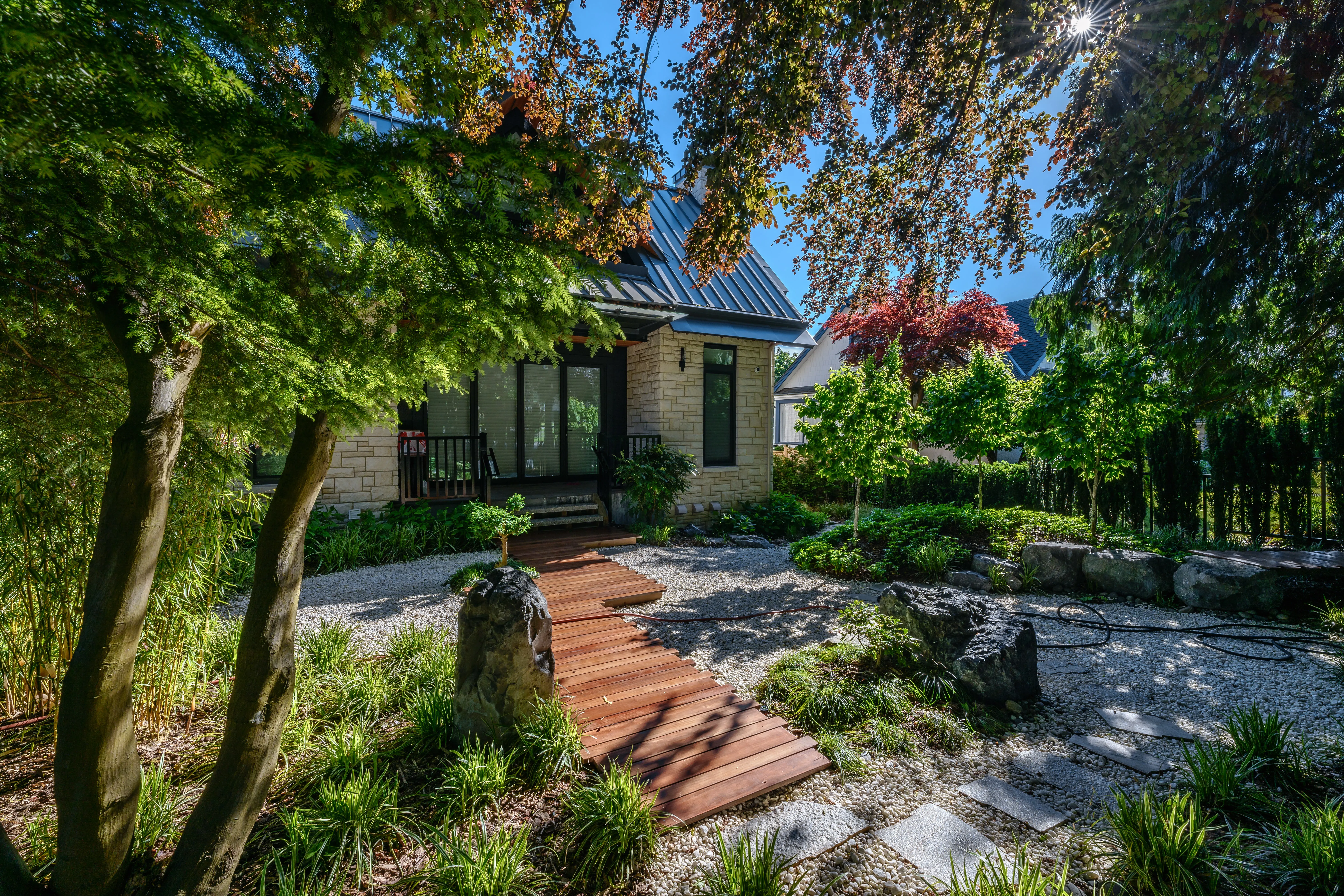 Timber boardwalk through a shaded garden at Hudson Street