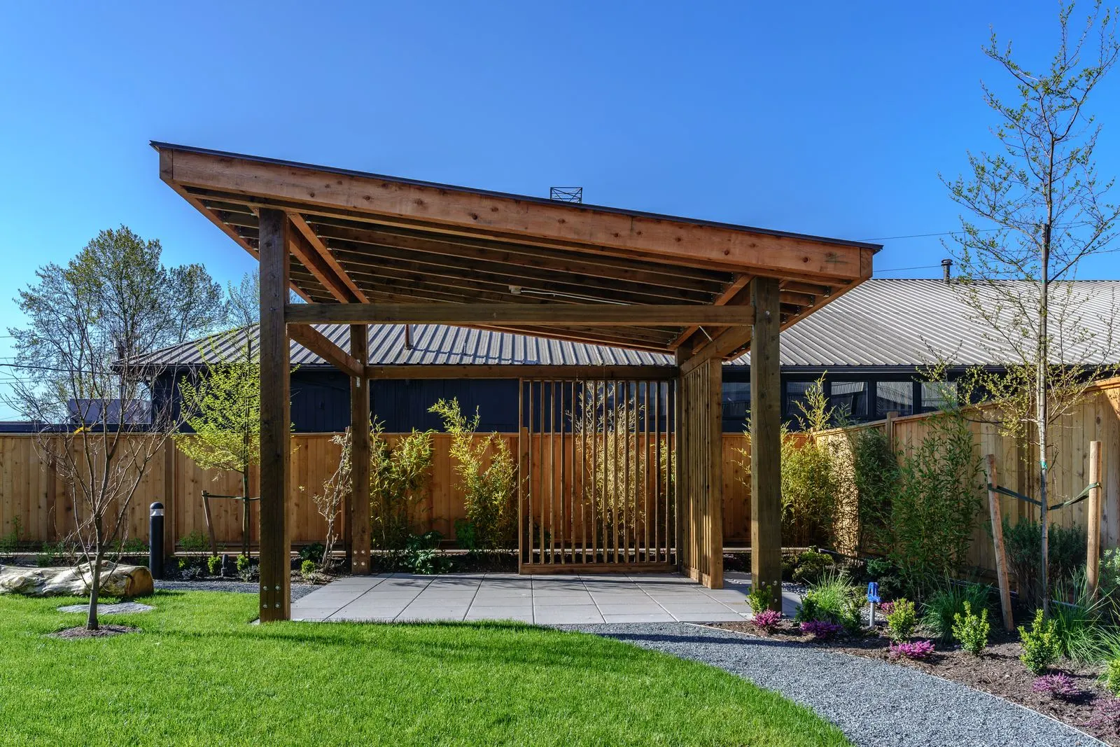 Timber pavilion beside a lawn at The Grove Presentation Centre