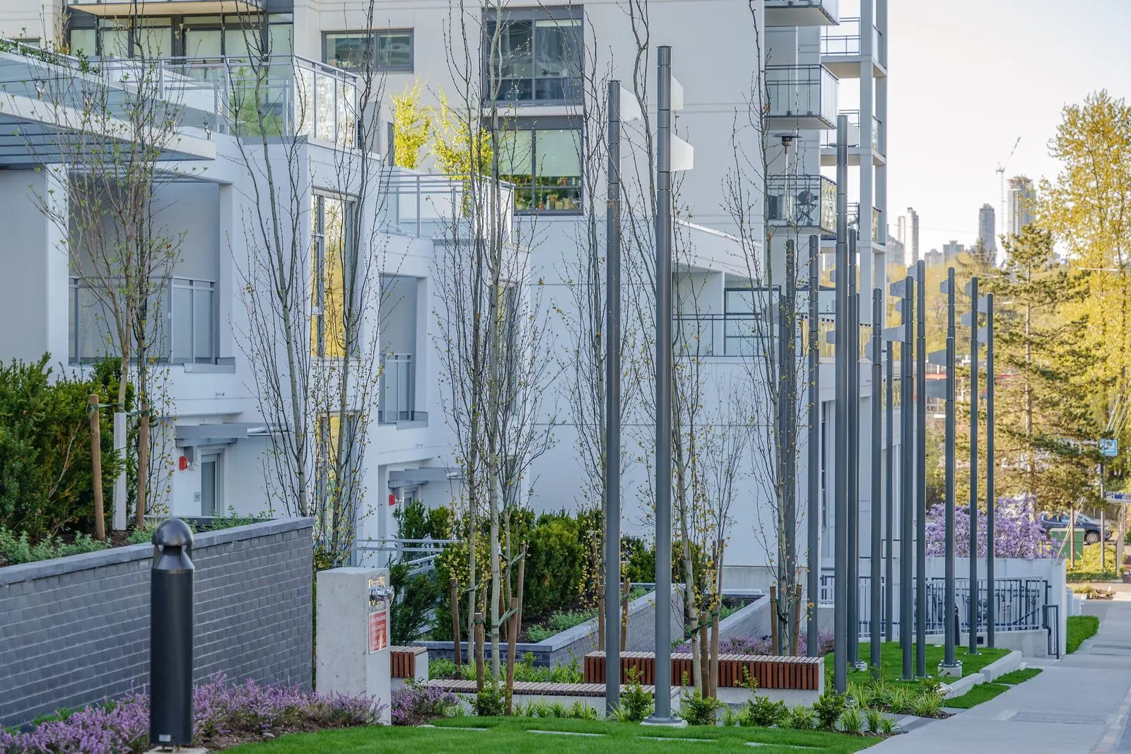 Vertical poles and planting along a residential frontage at Alpha Lumina