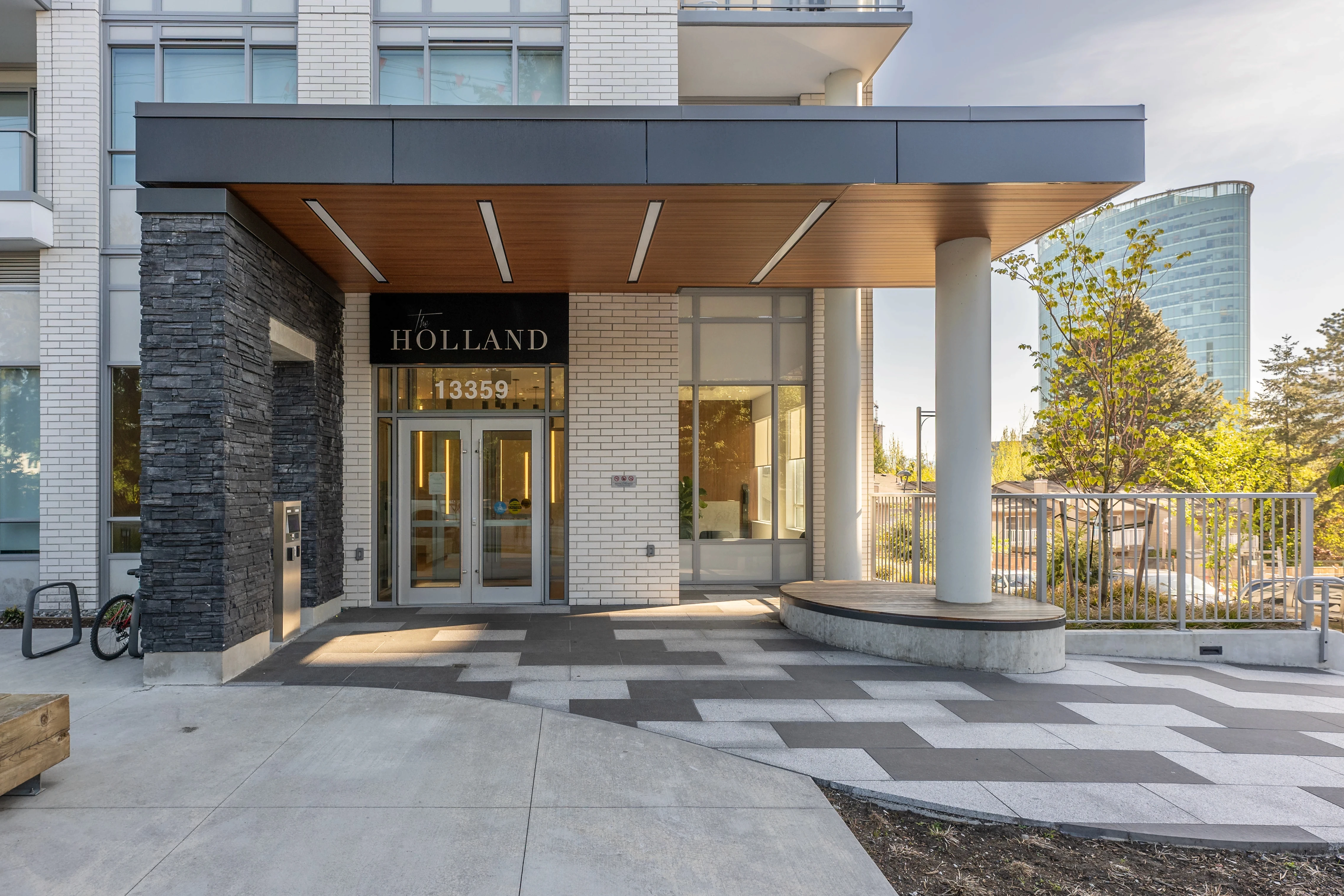 Entrance canopy and patterned paver plaza at The Holland