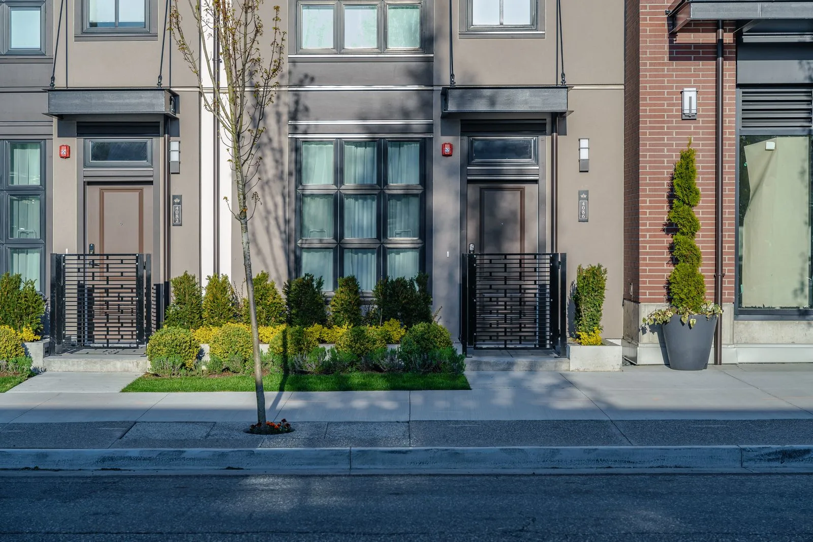 Front yard planting and entry gates along townhomes at Westbury Townhomes