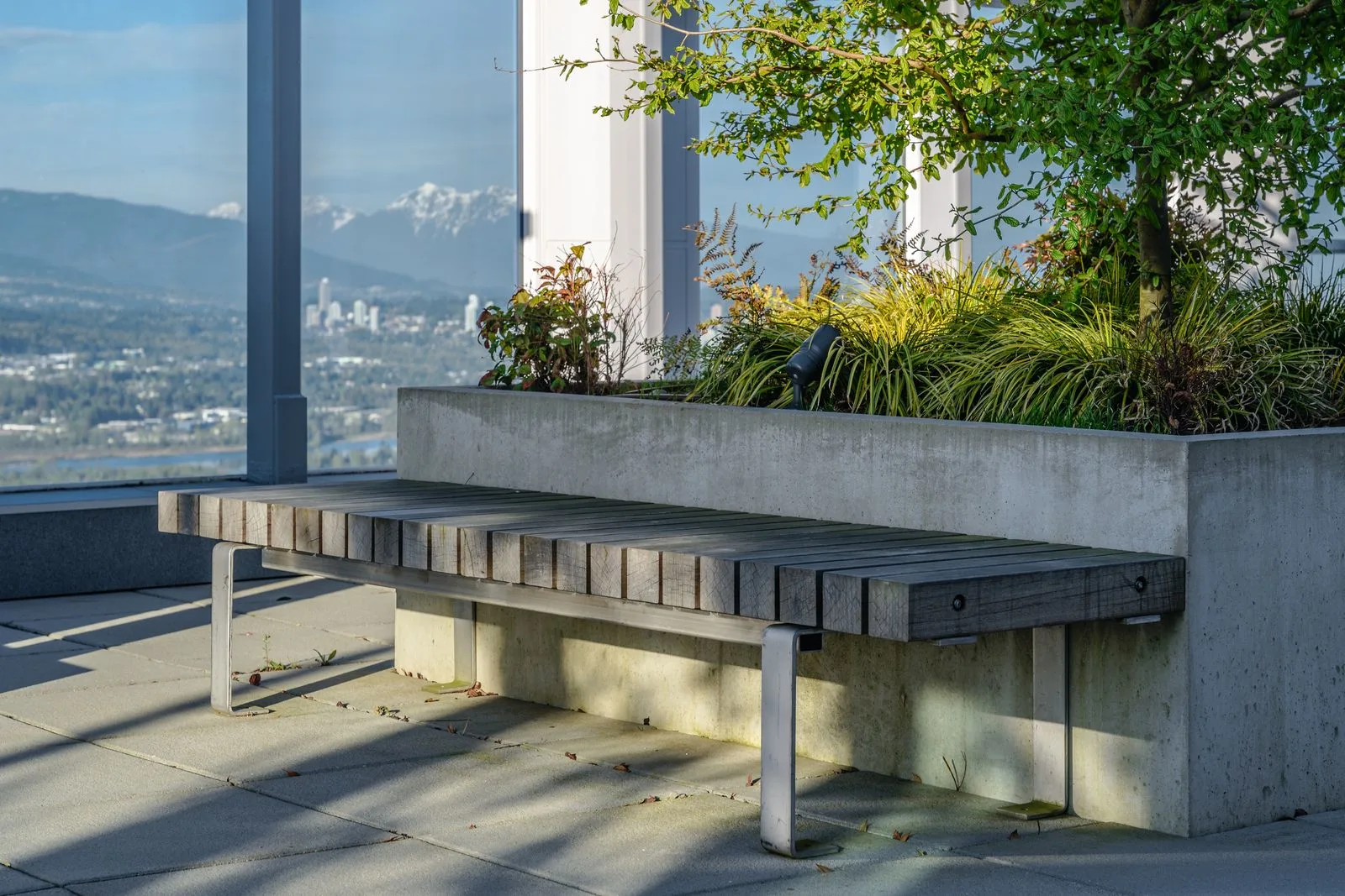 Concrete planter and bench inside a glass-walled terrace at Station Square 2 and 3
