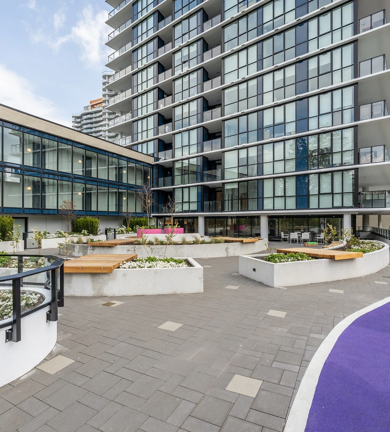Courtyard with raised planters and timber seating at Melrose