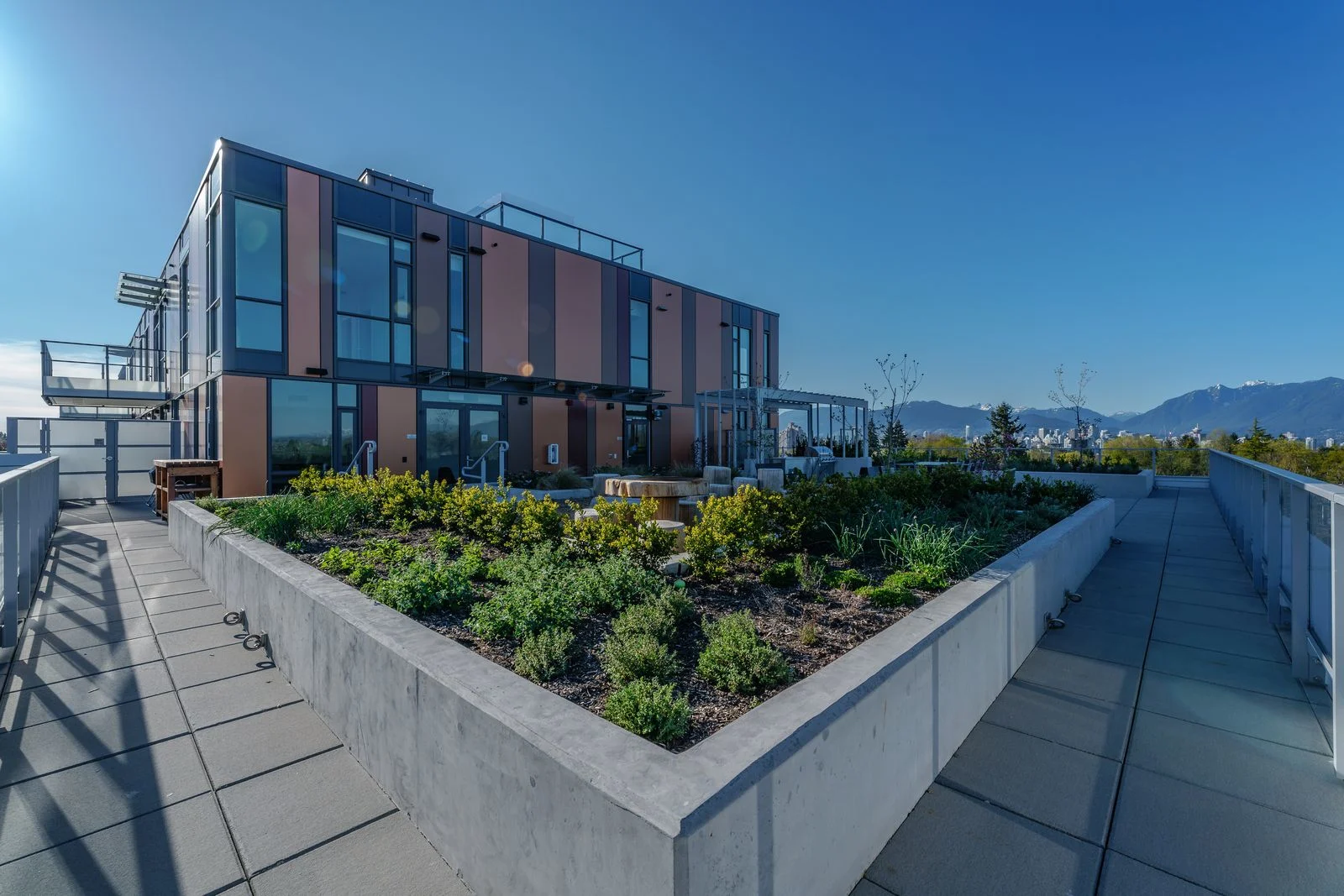 Rooftop walkways around a raised planting bed at Marquise