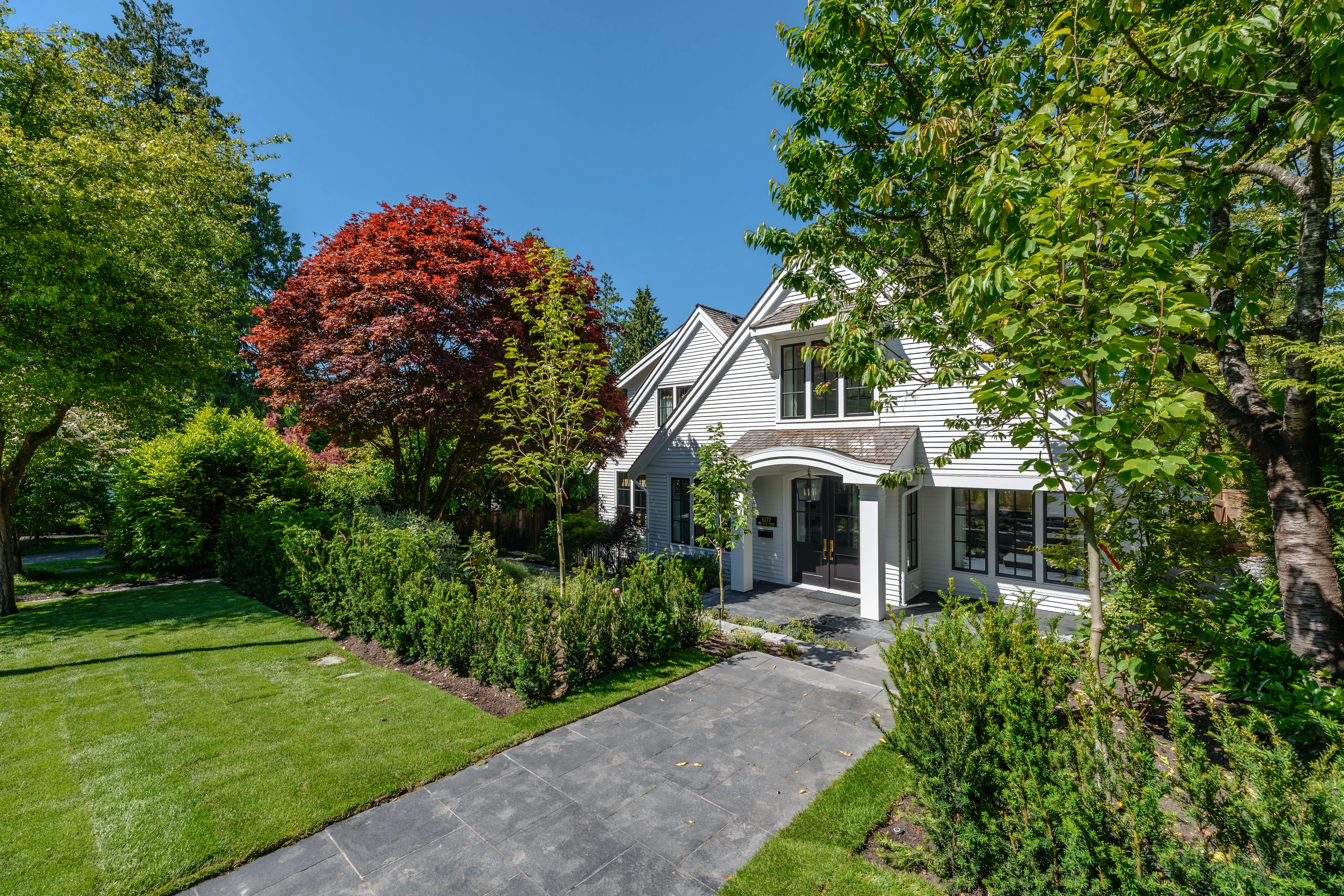 Front lawn and paved walkway leading to a house at MacKenzie