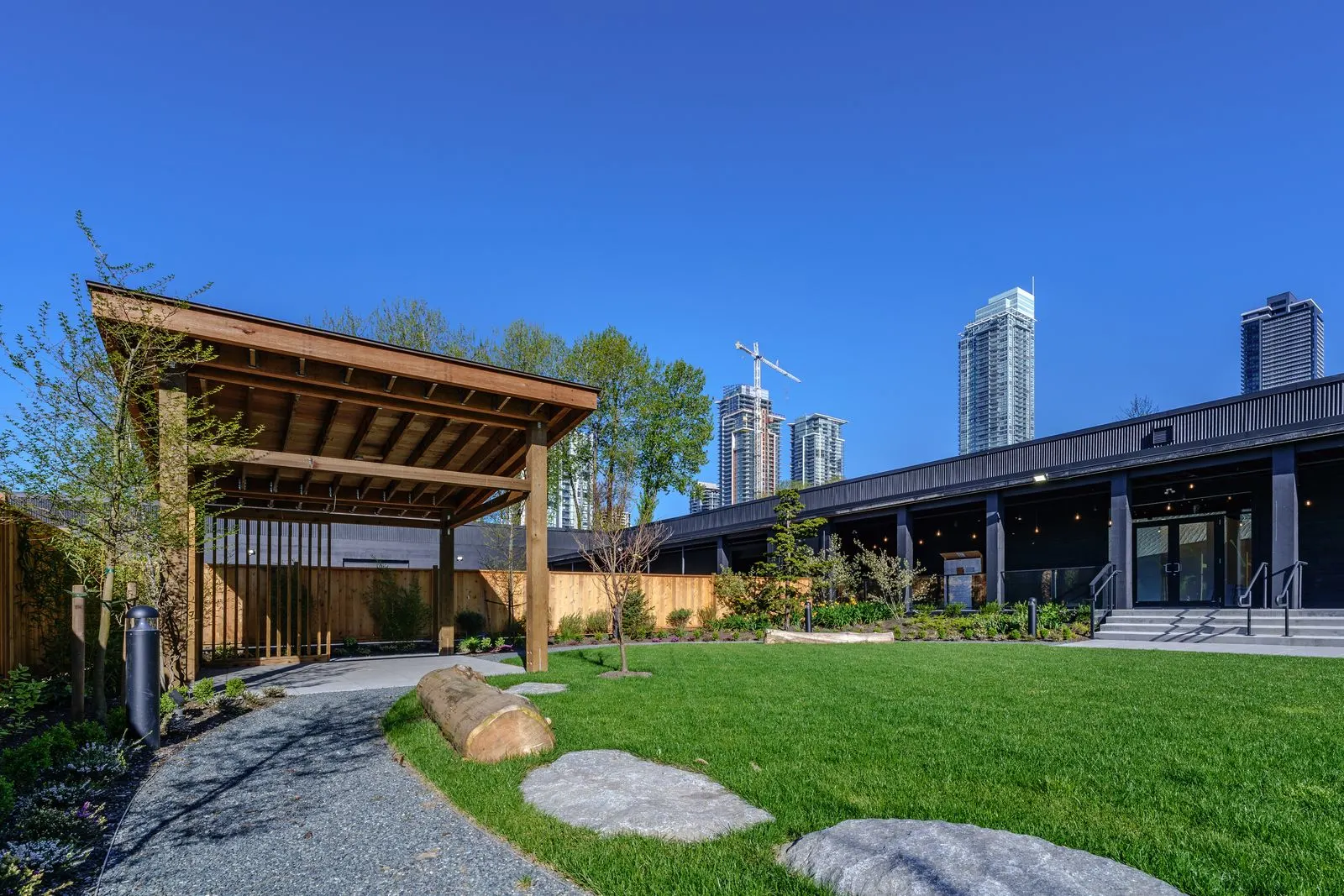 Timber pavilion, stepping stones and lawn at The Grove Presentation Centre