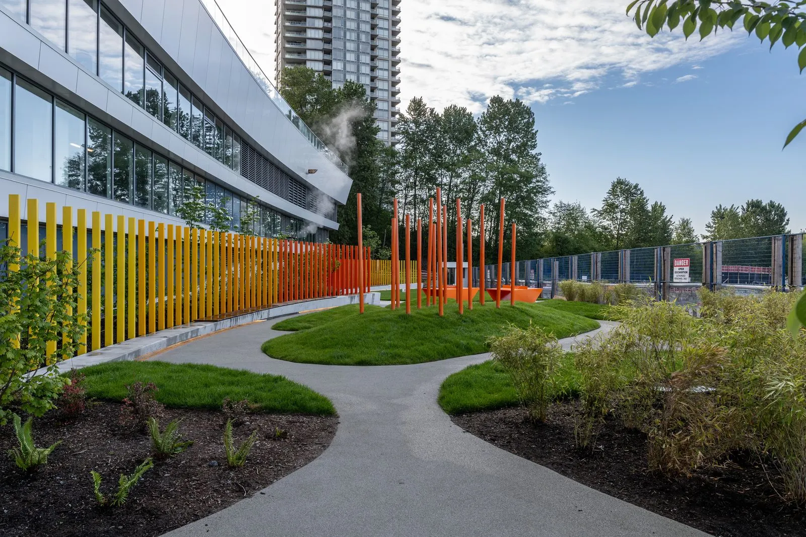 Curved paths through grass mounds beside coloured vertical fins at Brentwood 1B