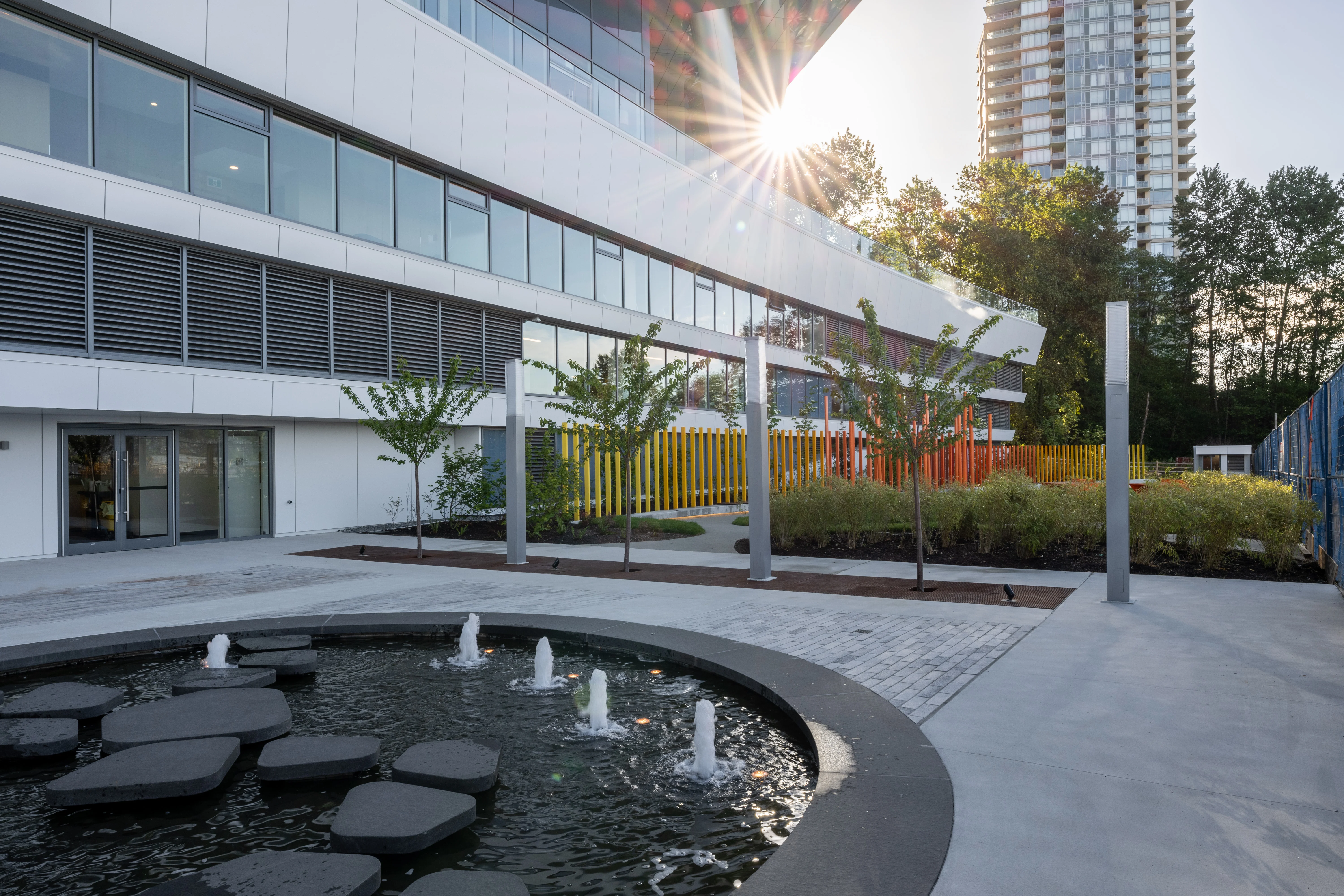 Circular water feature with stepping stones and fountain jets in a plaza