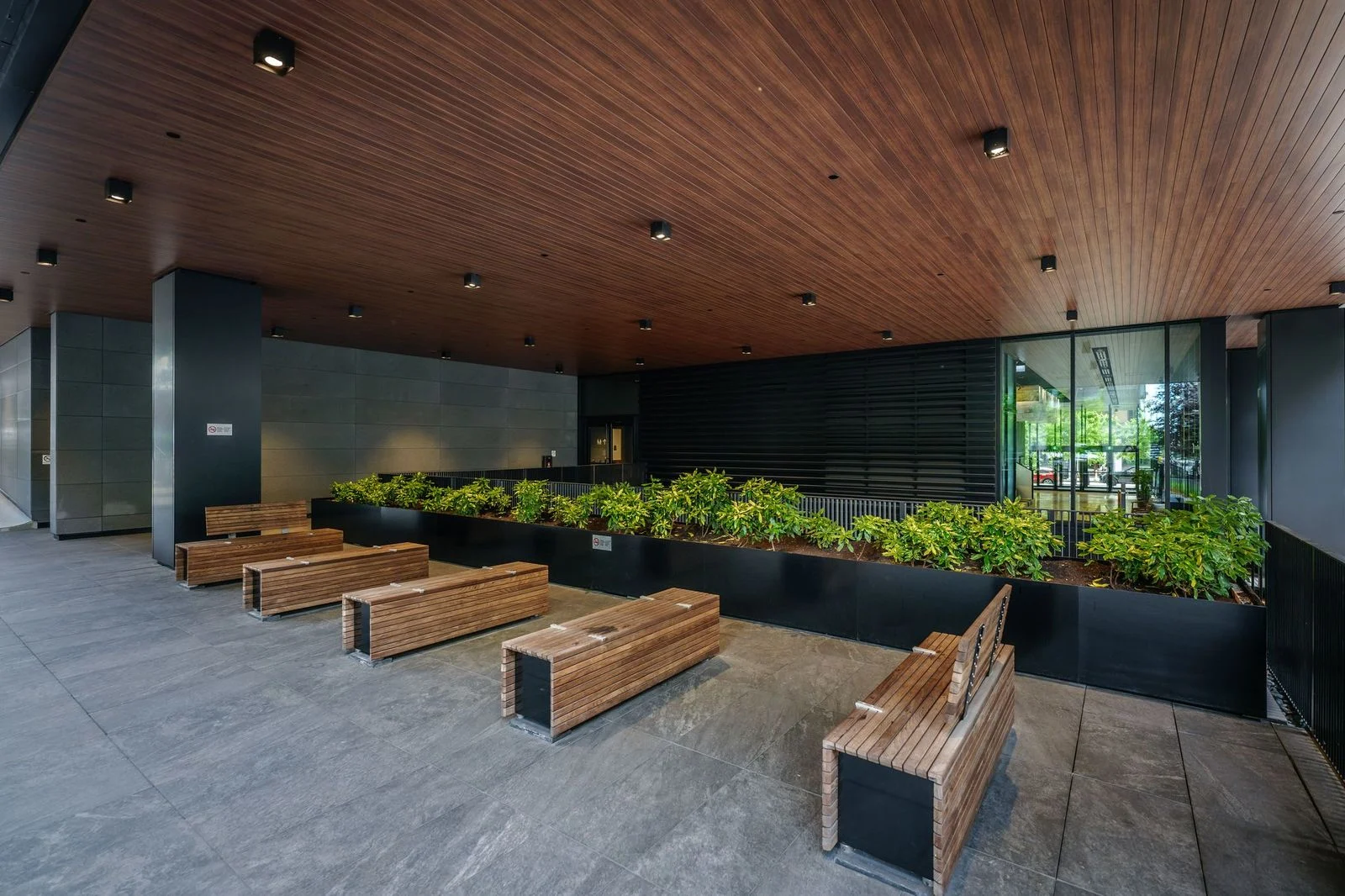 Covered terrace with timber benches and planters at Amazon Downtown