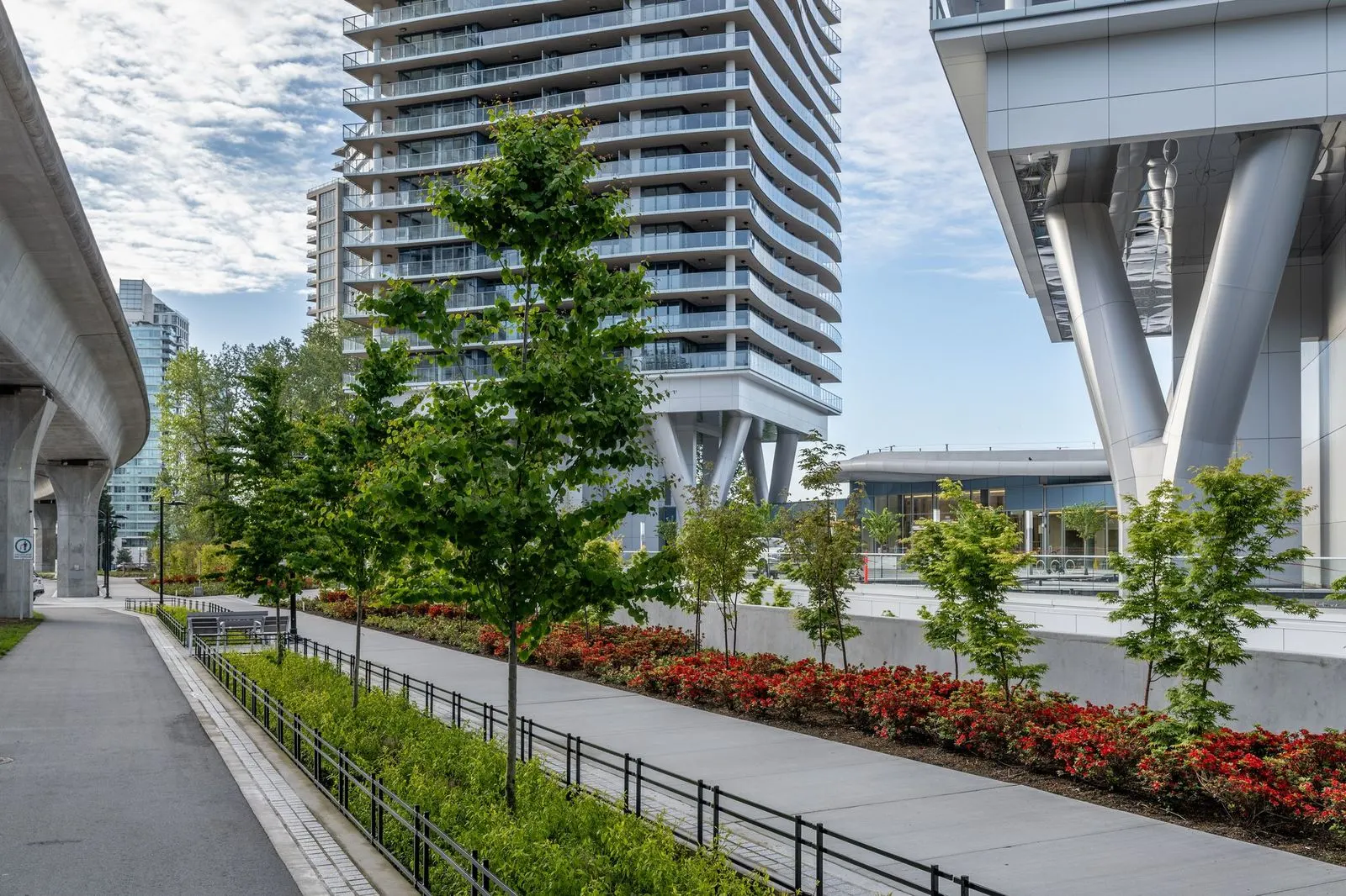 Pathway with young trees and planting beside a tower at Brentwood 1B