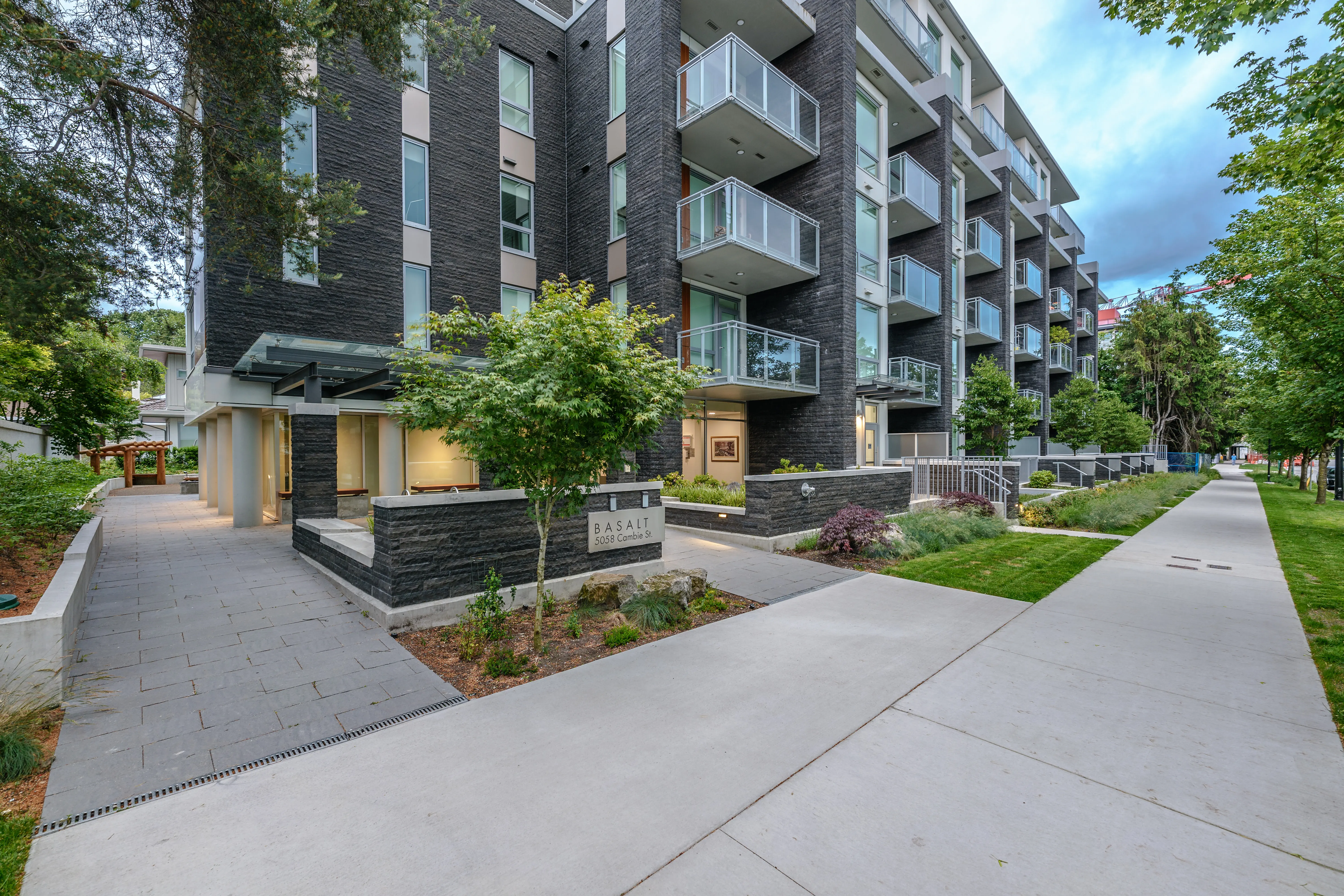 Curved concrete walkways and planting at a residential entrance at Basalt