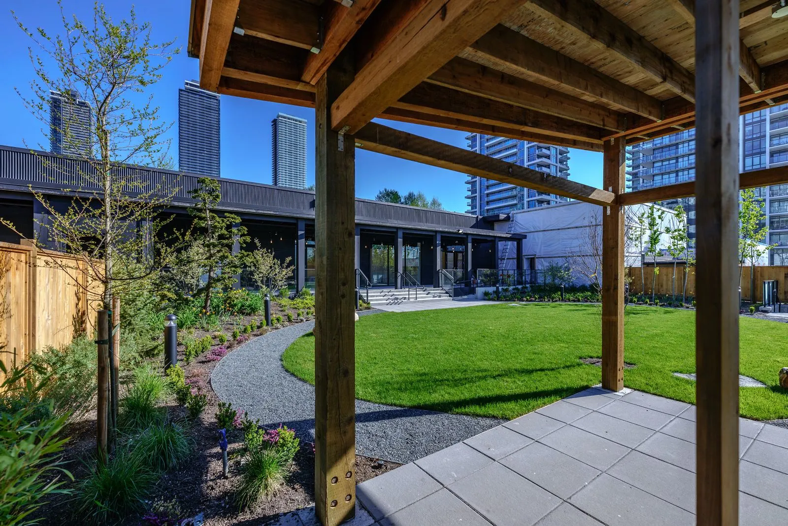 Lawn and planting seen from under a timber pavilion at The Grove Presentation Centre