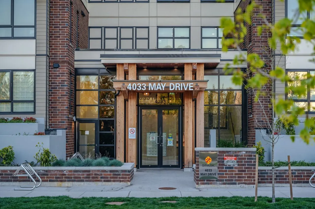 Building entrance with planting and young trees at Spark