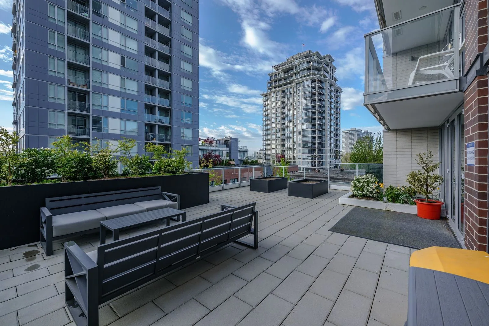 Rooftop terrace with benches and planters at The Beverley