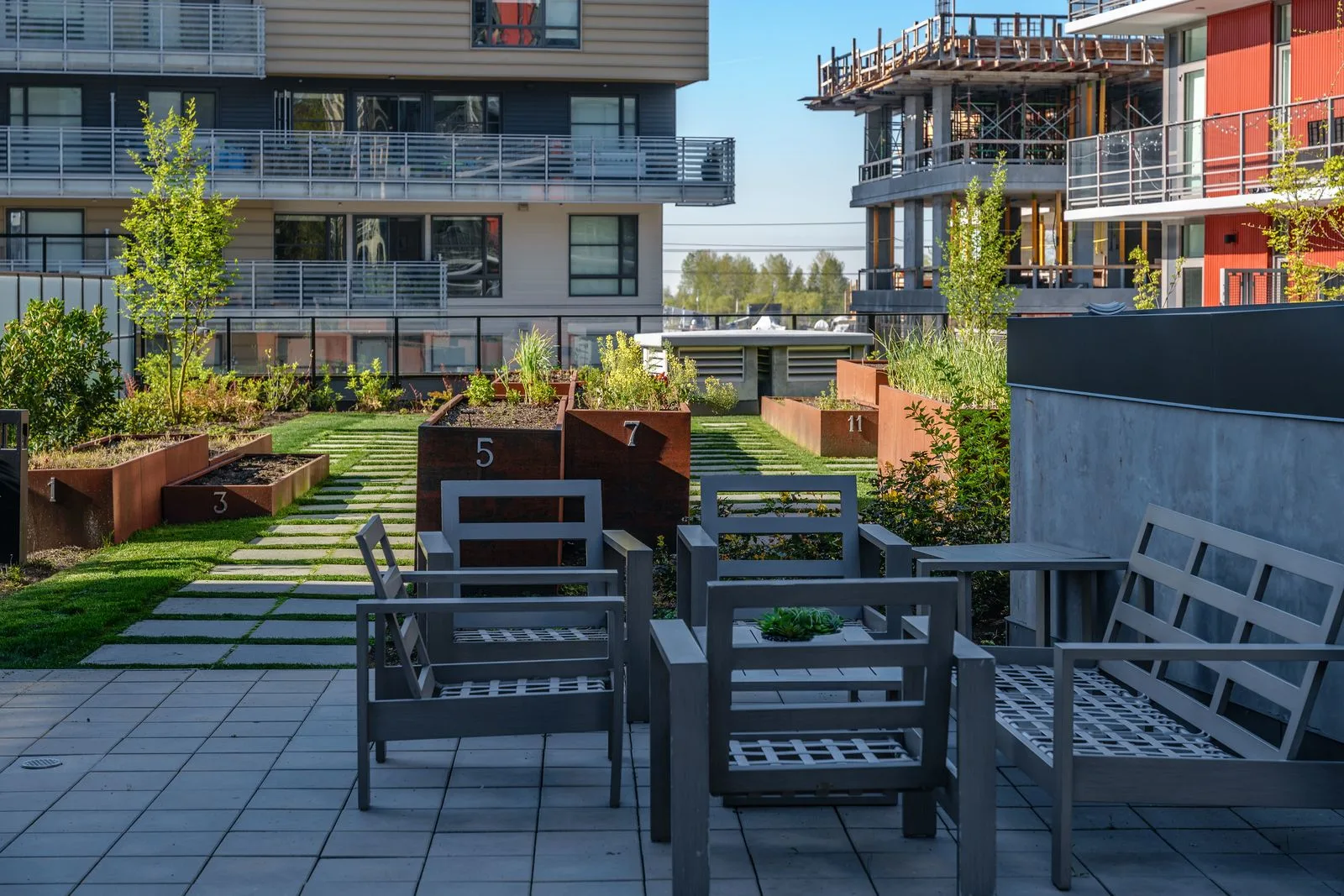 Patio seating beside courtyard planters at Quartet