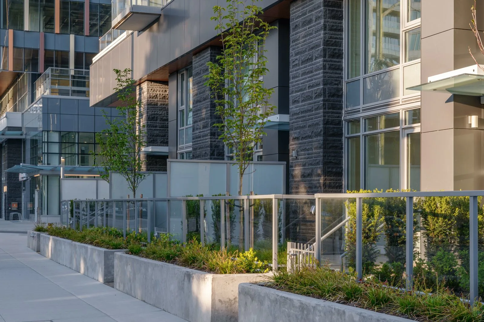 Raised concrete planters along a townhome frontage at Sun Tower II