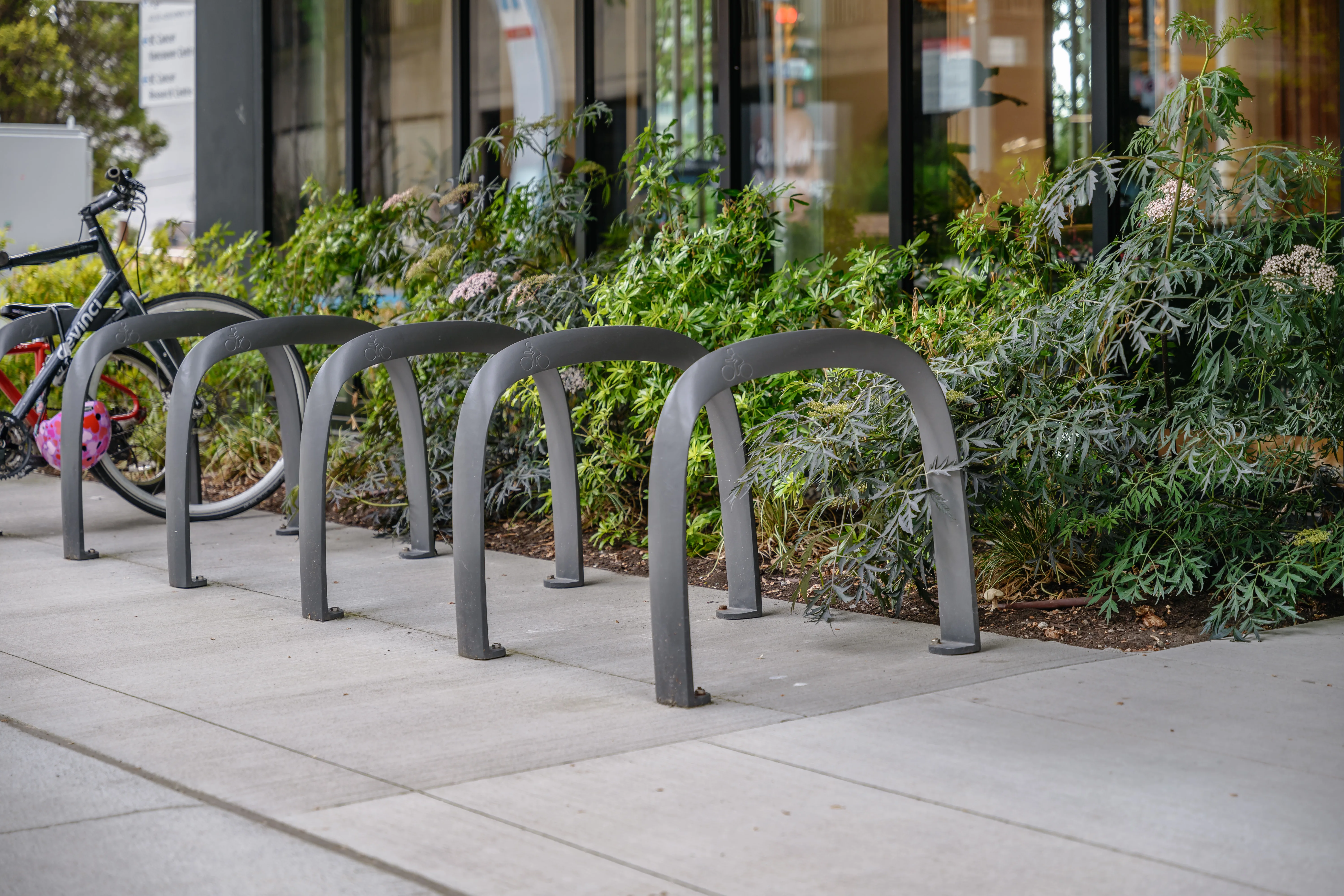 Bike racks in front of shrub planting at Canadian Cancer Society