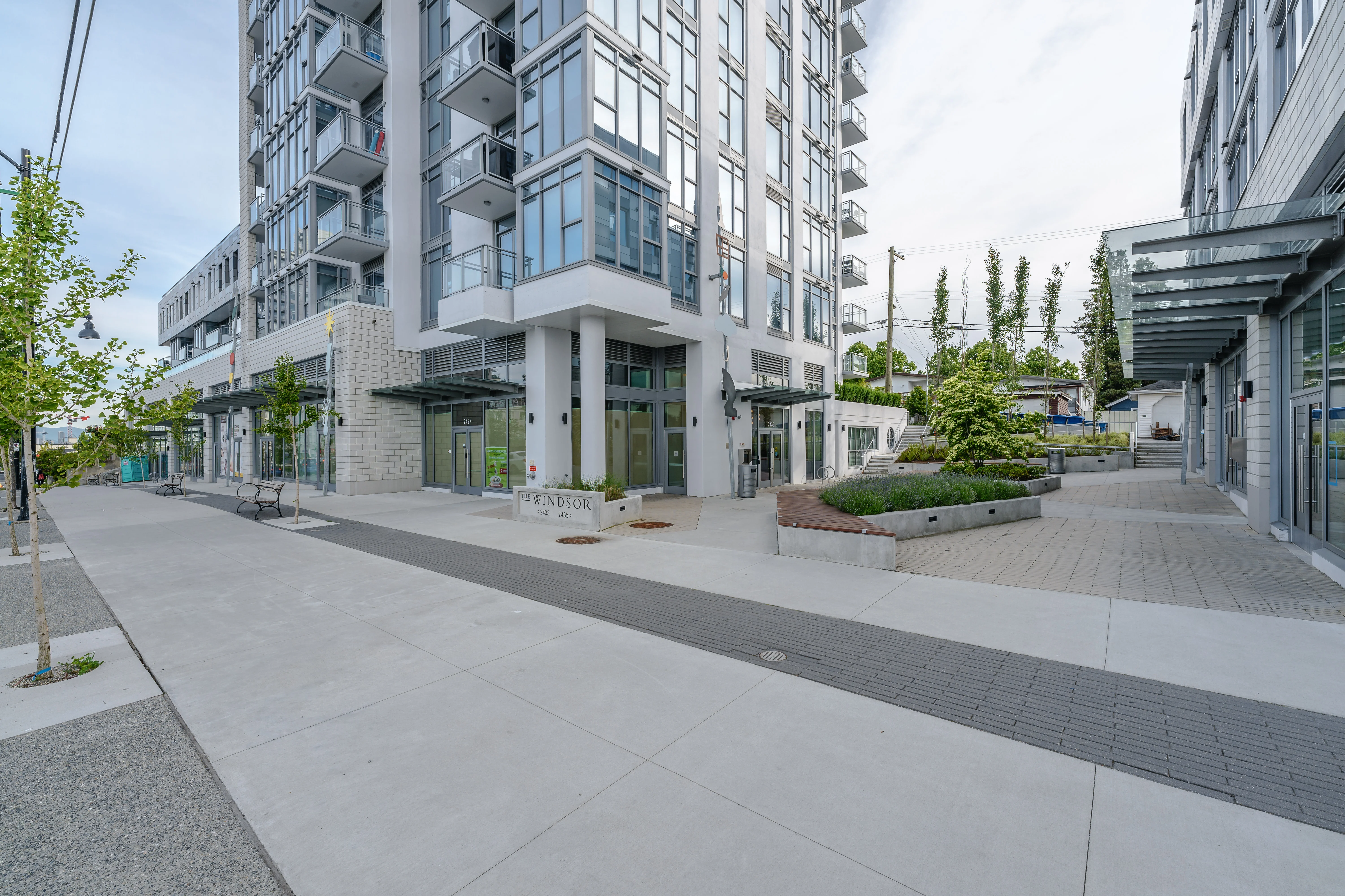 Paved plaza and walkway at the base of a residential tower at The Windsor