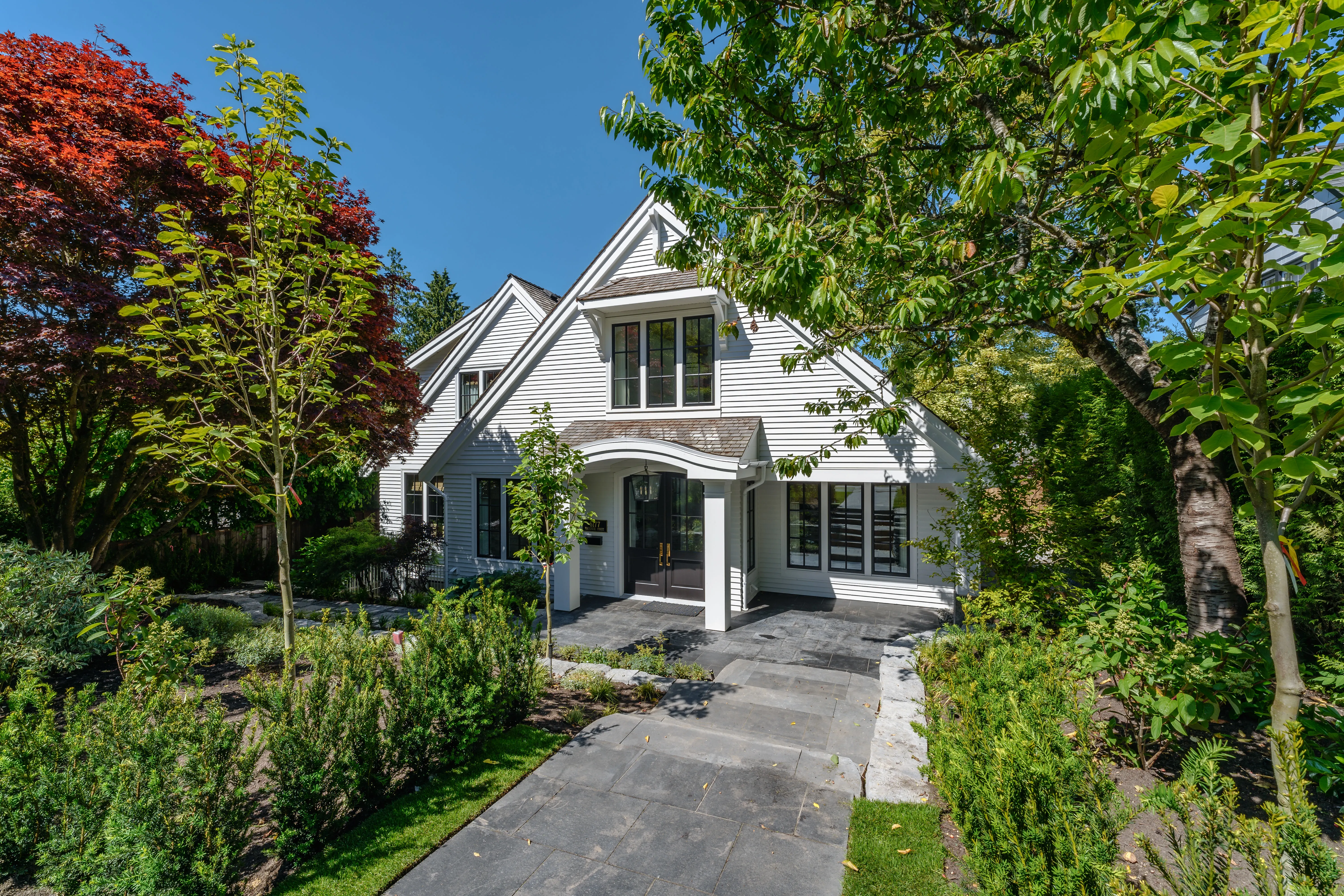 Paved walkway through planting to a house entry at MacKenzie